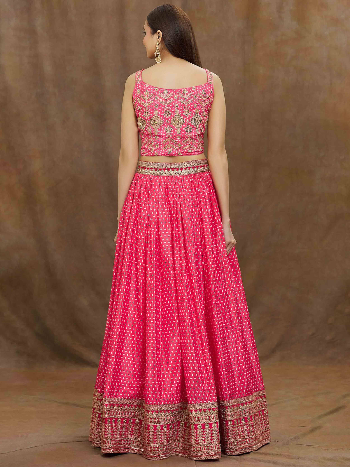 Pink embroidered lehenga choli with gold detailing, perfect for ethnic occasions