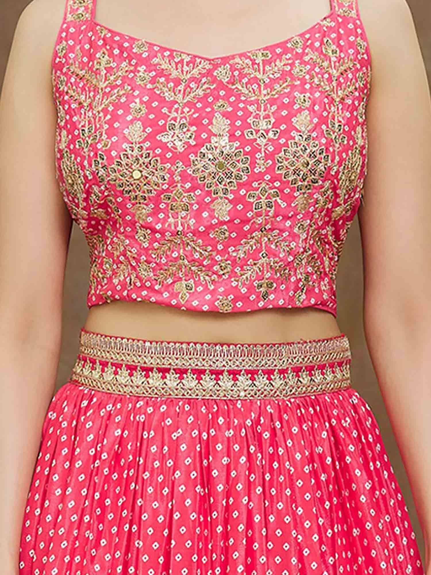 Pink embroidered lehenga choli with gold floral patterns and diamond motifs