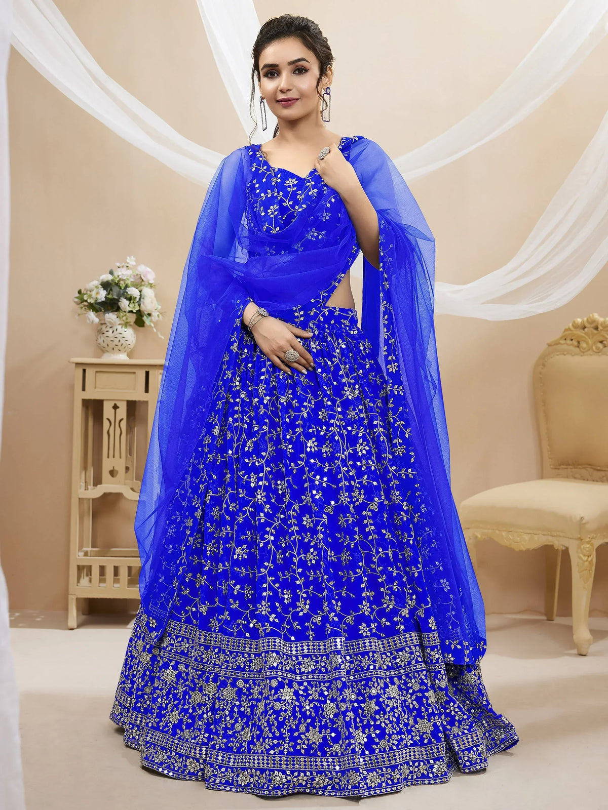 Royal blue embroidered lehenga choli with floral zari work and sheer dupatta, perfect for Indian weddings and festive occasions.