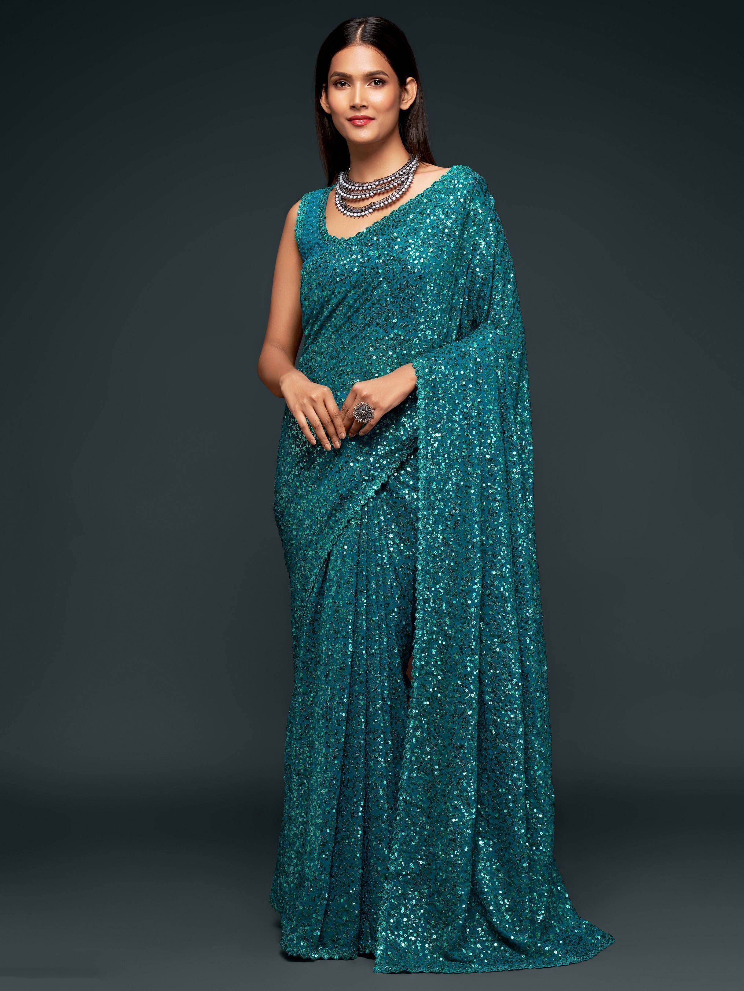 Teal sequin saree with sleeveless blouse, perfect for Indian ethnic wear and festive occasions.