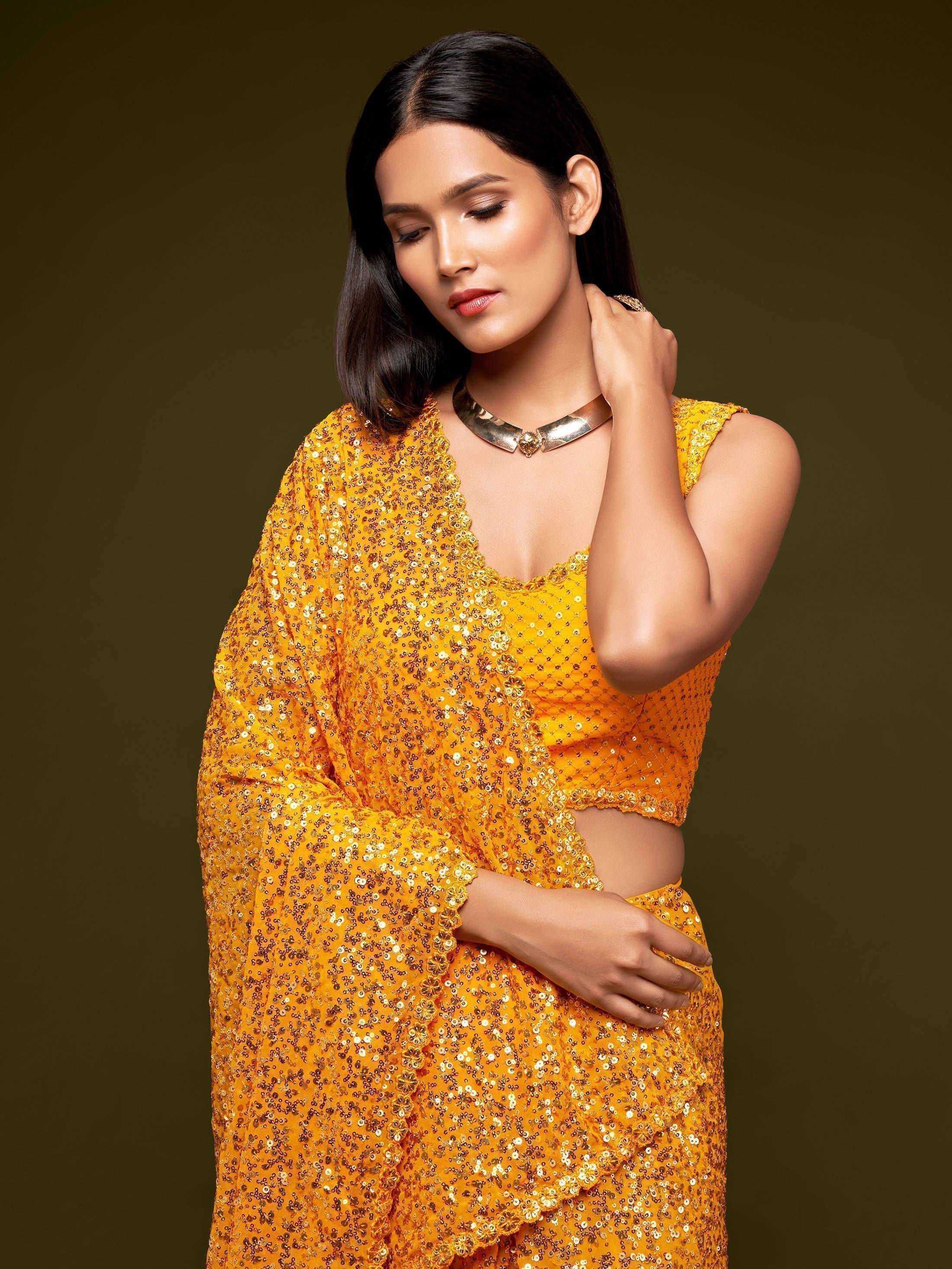 Yellow sequin ethnic gown with flared sleeves and V-neck, perfect for festive occasions