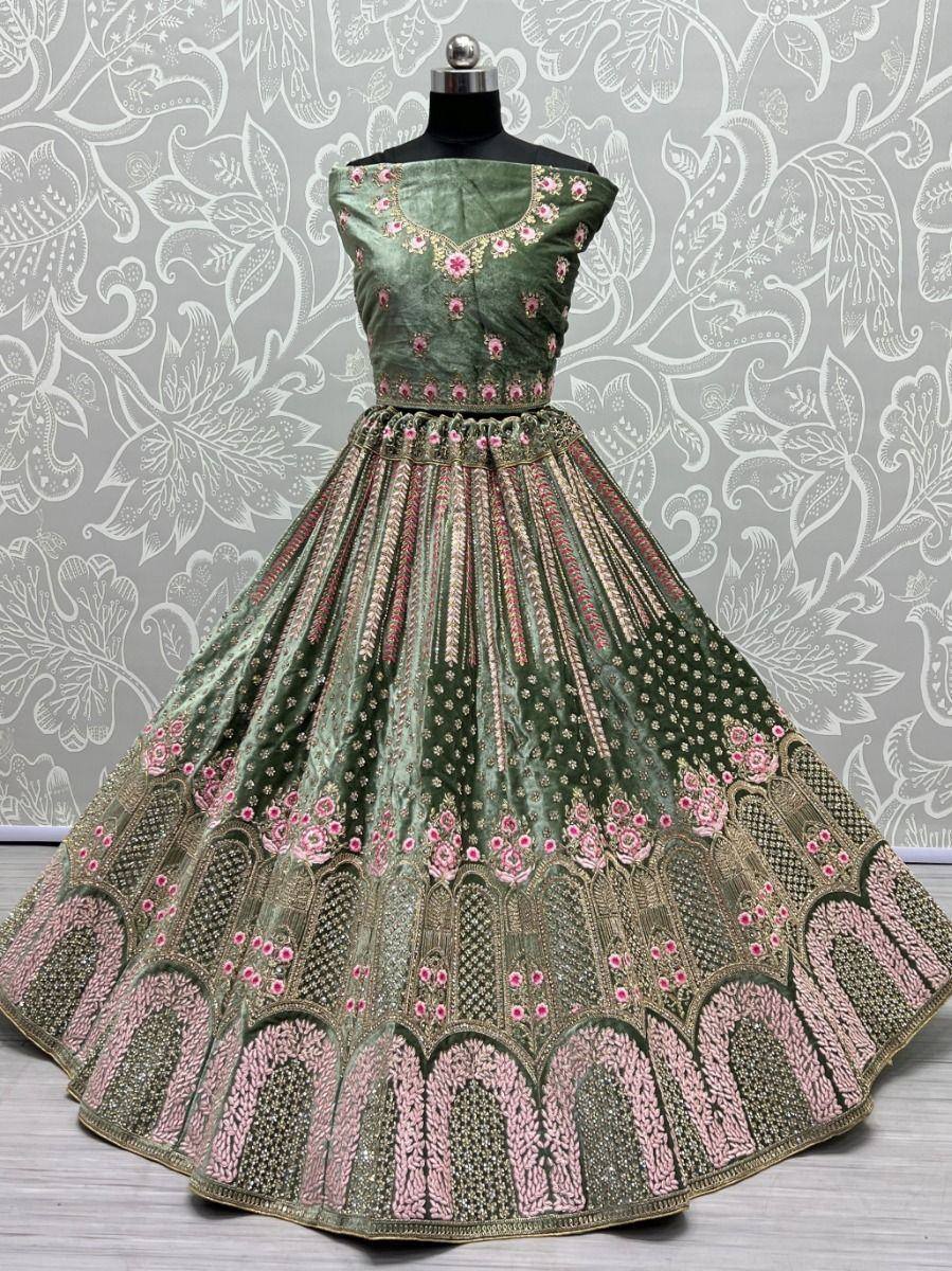 Green velvet lehenga choli with pink floral embroidery and gold detailing, perfect for Indian ethnic wear occasions