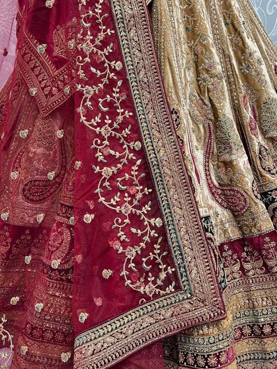 Luxury maroon and gold embroidered lehenga choli with intricate floral and paisley designs, perfect for Indian weddings.