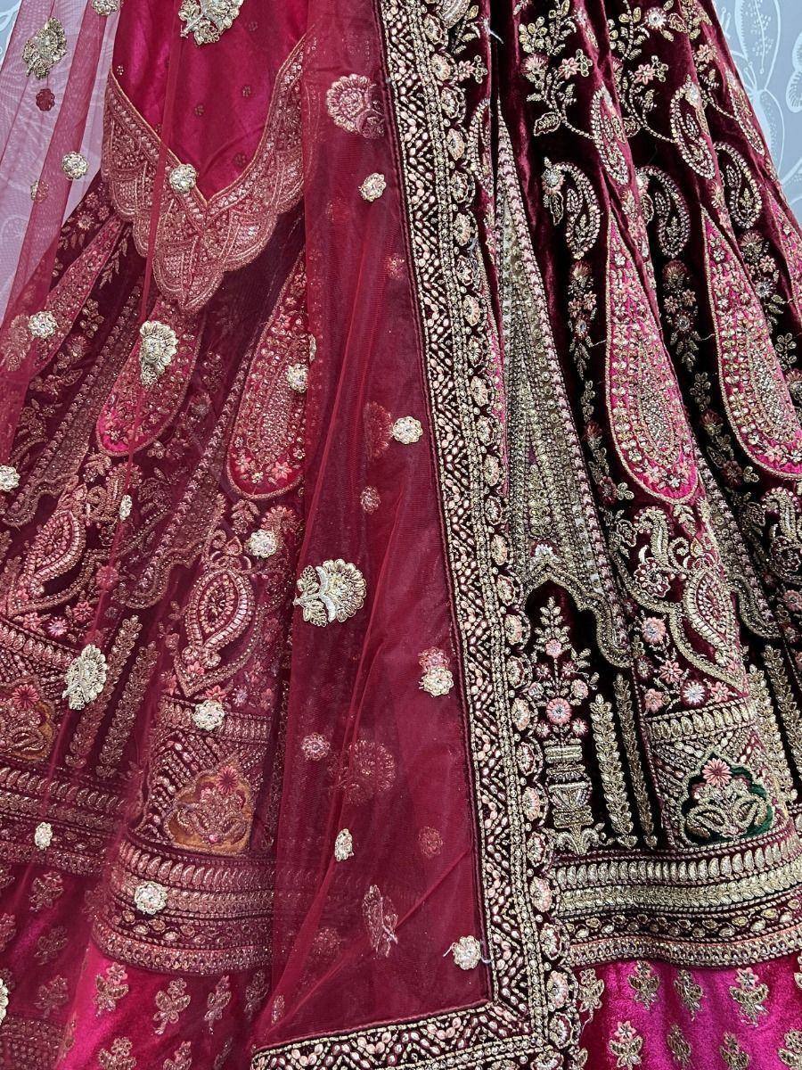 Luxury maroon lehenga choli with intricate gold embroidery and velvet fabric, perfect for Indian weddings.