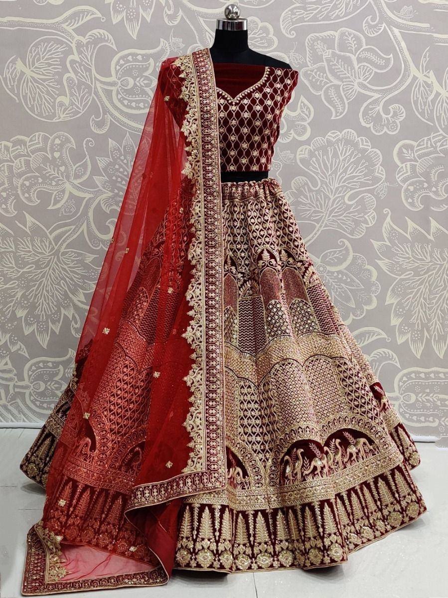 Maroon and gold designer lehenga choli with intricate embroidery and sheer dupatta, perfect for weddings