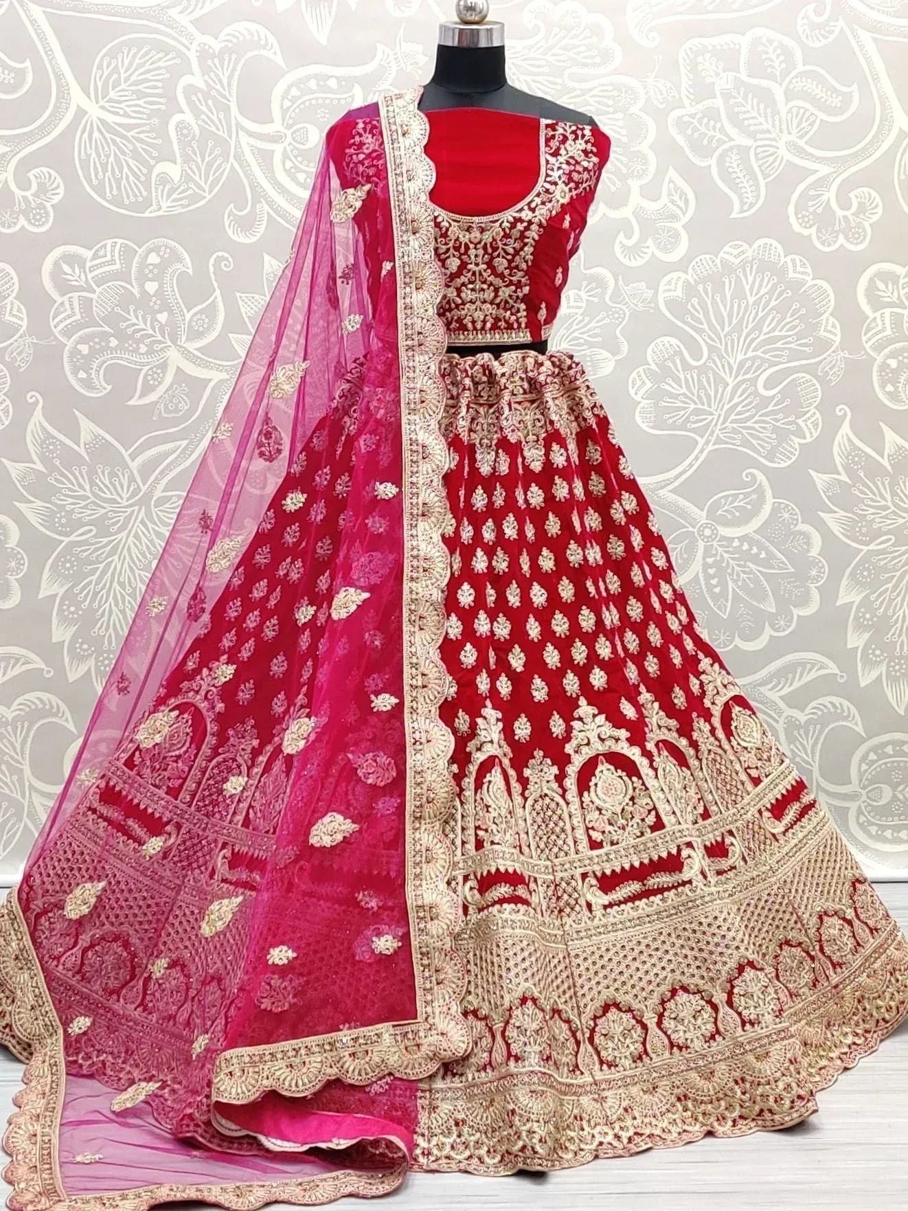 Red and pink embroidered lehenga choli with gold detailing, perfect for Indian weddings and festive occasions.