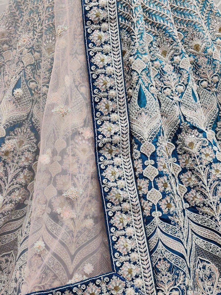Blue velvet lehenga with intricate white embroidery and sheer dupatta, perfect for Indian ethnic wear.