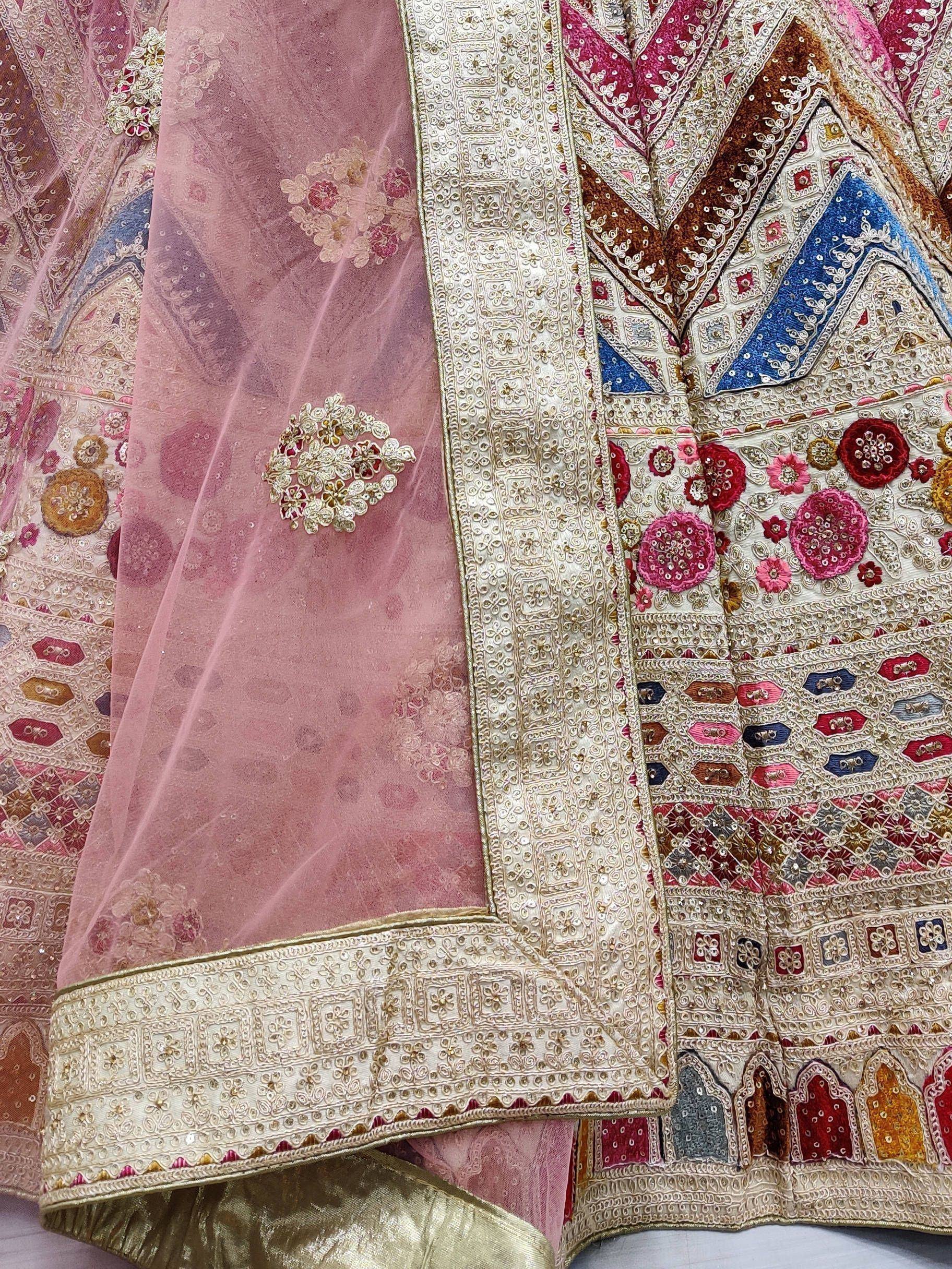 Designer lehenga choli with intricate embroidery, floral motifs, and sheer dupatta for Indian ethnic wear