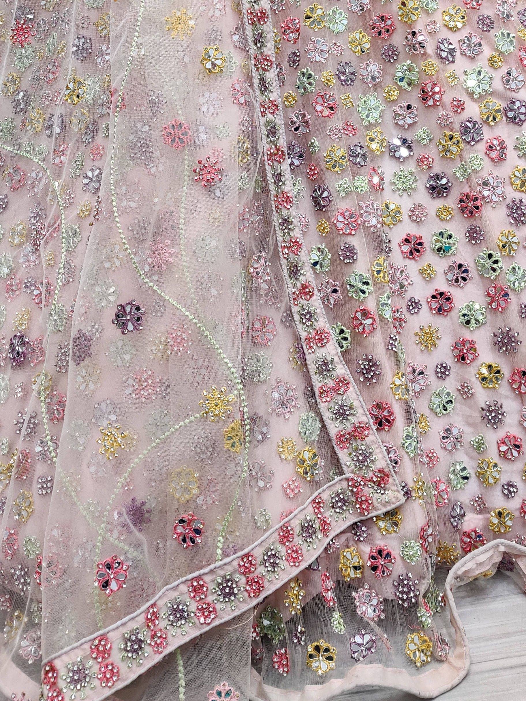 Pink sheer ethnic gown with multicolor floral mirror and bead embroidery, perfect for Indian celebrations.