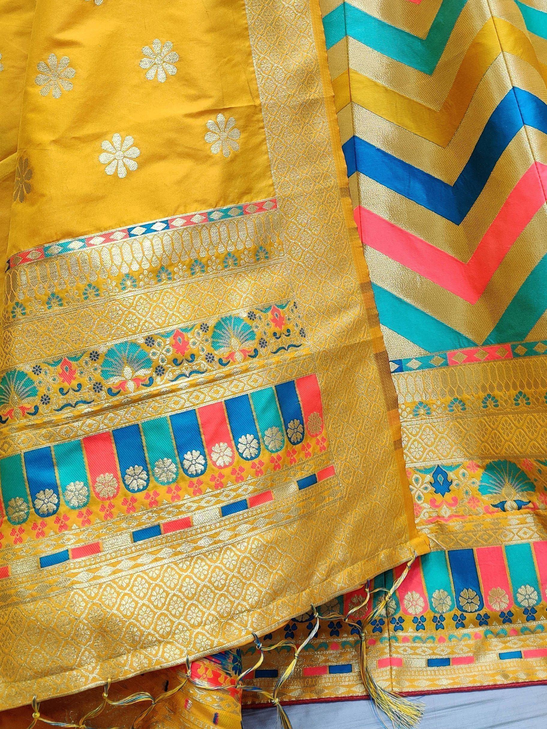 Vibrant yellow saree with floral motifs and colorful chevron border, ideal for ethnic wear occasions.