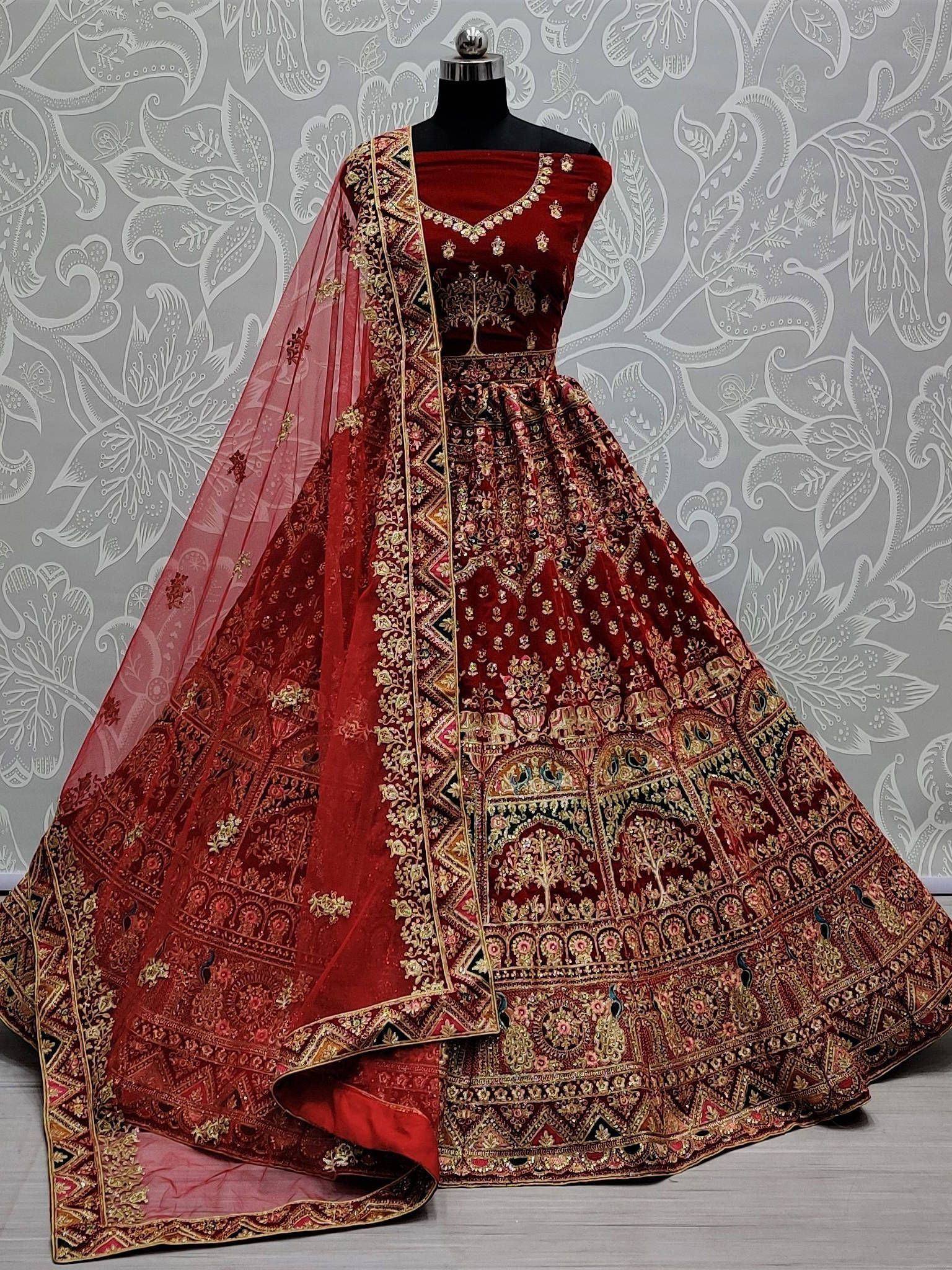 Red velvet designer lehenga choli with heavy gold embroidery and matching dupatta, ideal for weddings and festivals