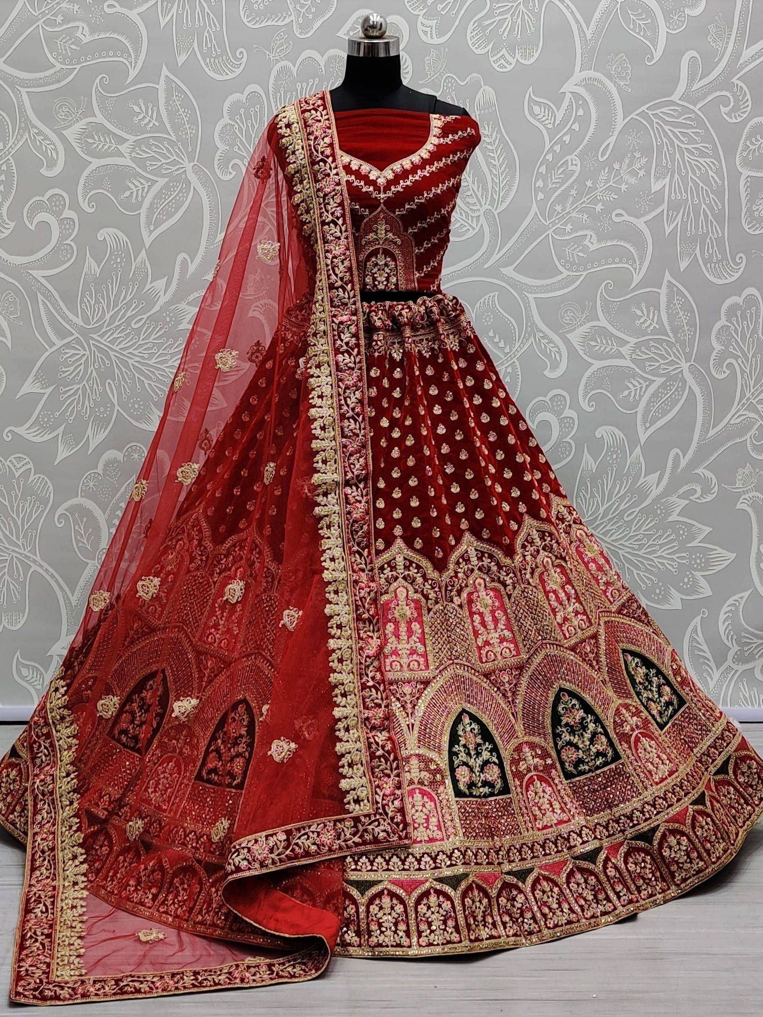 Red velvet designer lehenga choli with gold embroidery and sheer dupatta, ethnic Indian wear