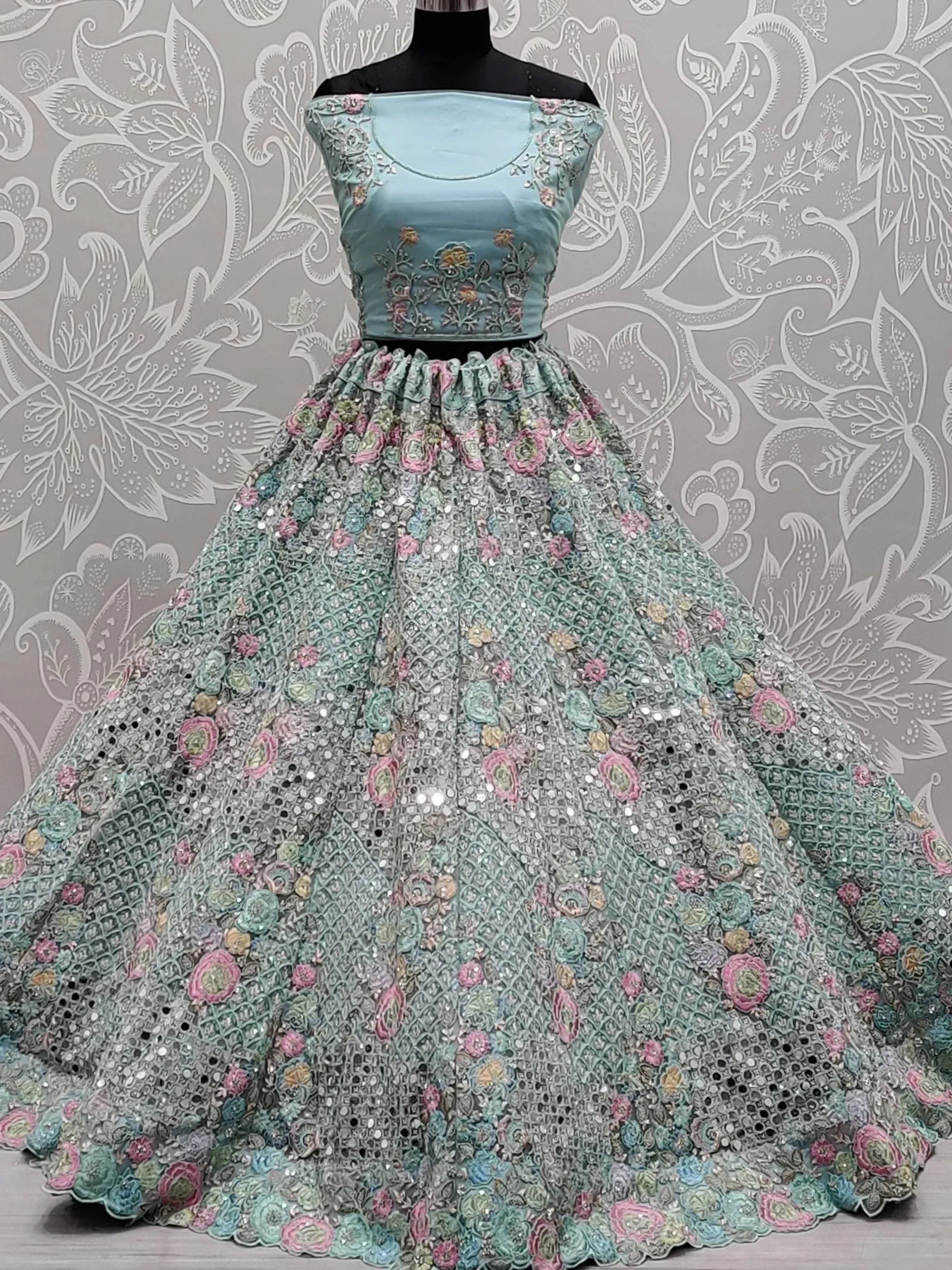 Mint green designer lehenga choli with floral embroidery and sequins, perfect for weddings and parties