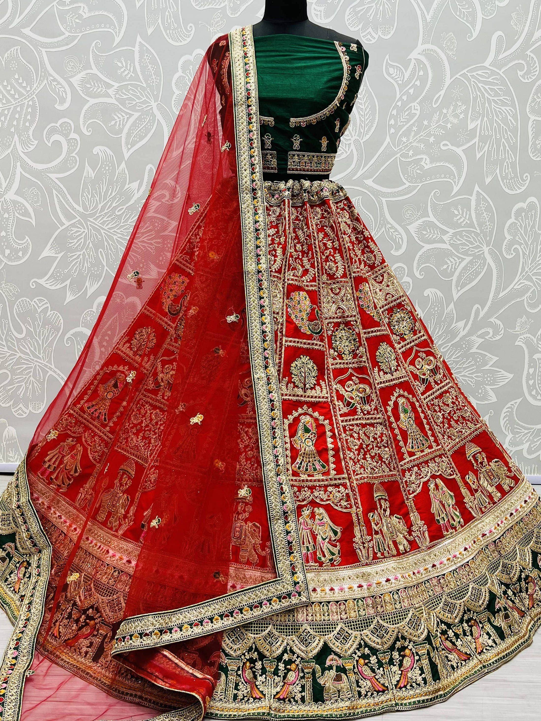 Red and green embroidered lehenga choli with intricate gold detailing and matching dupatta, perfect for Indian weddings and festive occasions.