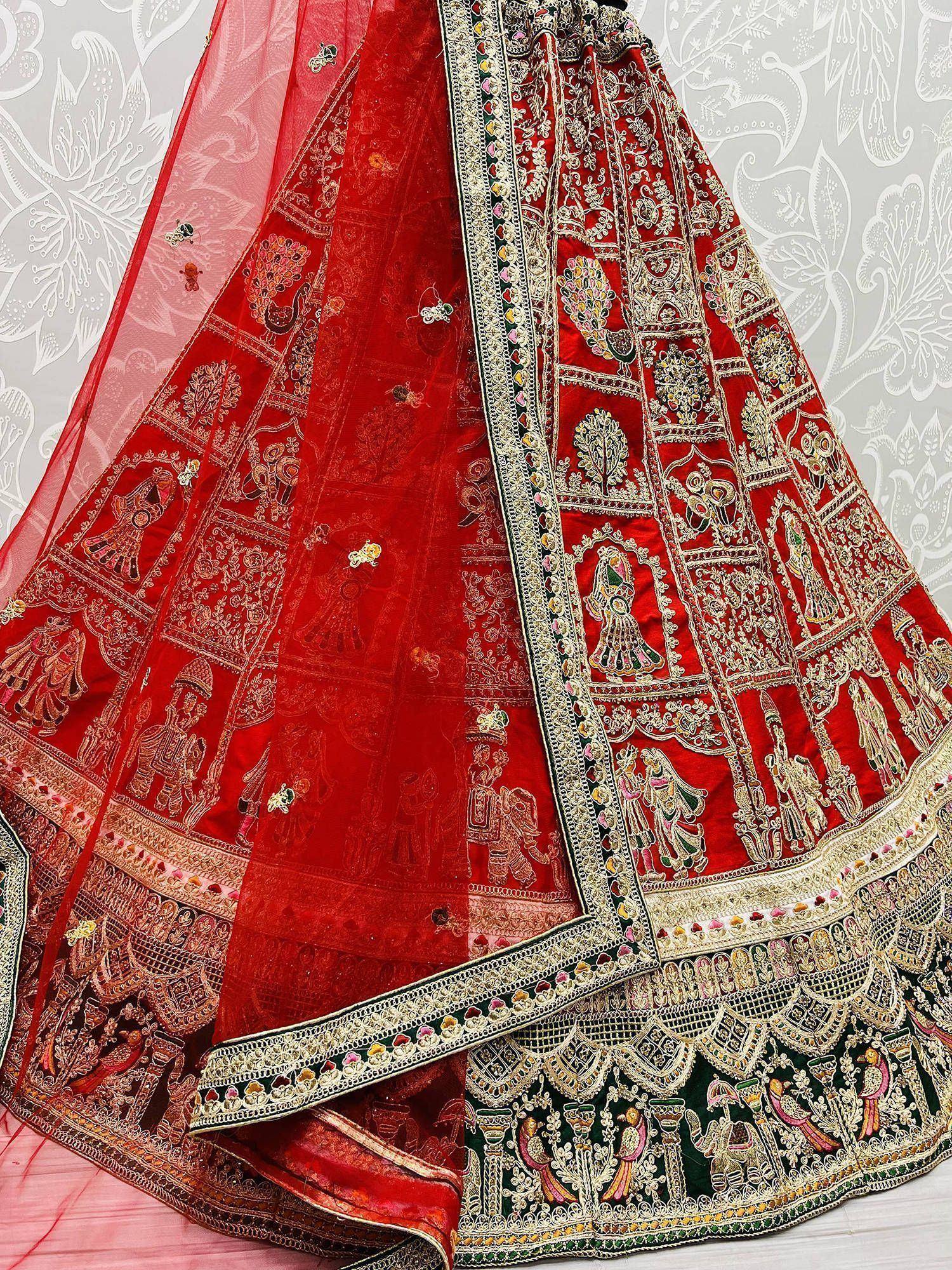 Red embroidered lehenga choli with intricate gold and multicolor mirror work, traditional Indian ethnic wear