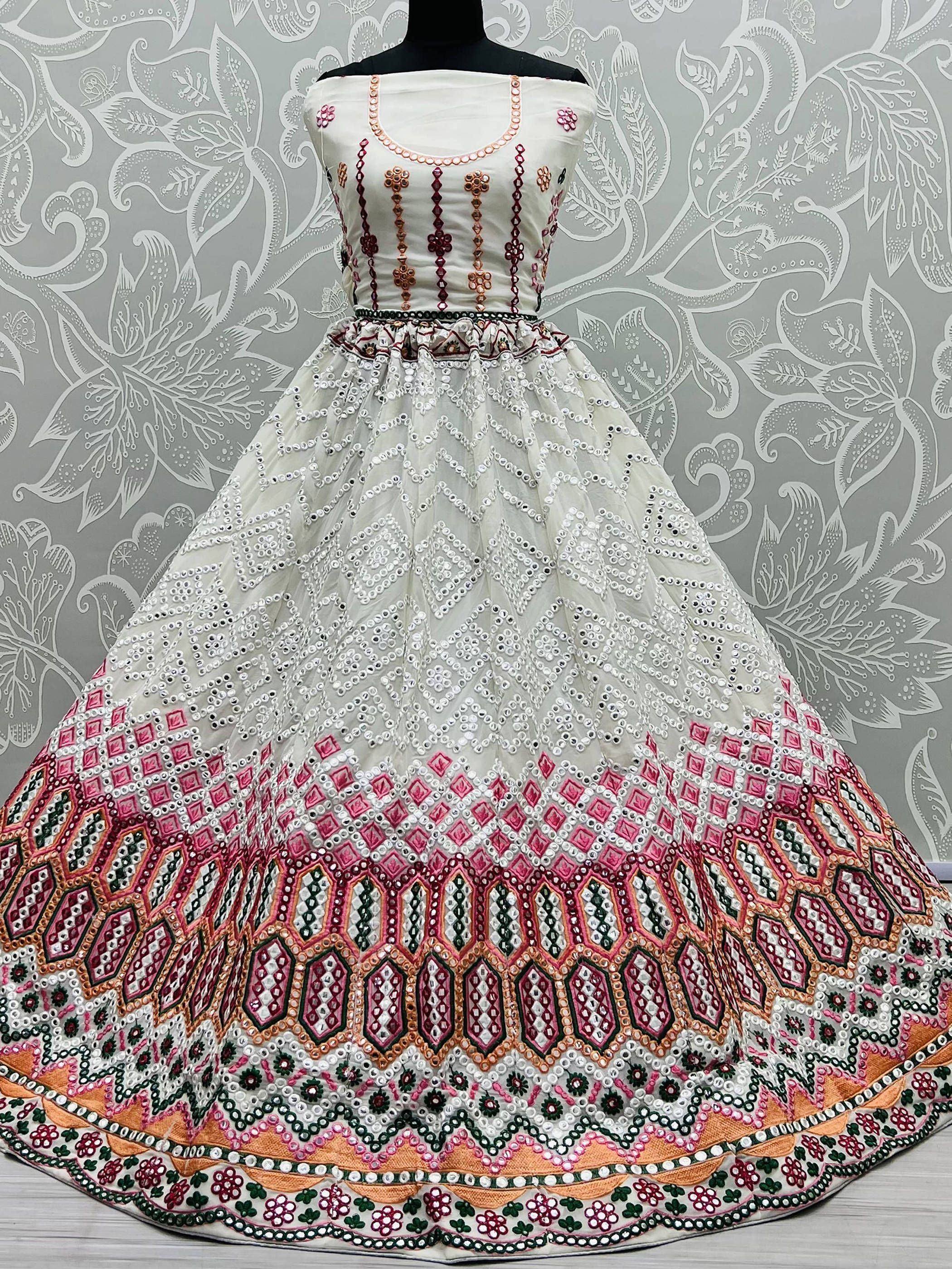 White ethnic gown with mirror work and pink green embroidery, perfect for Indian celebrations
