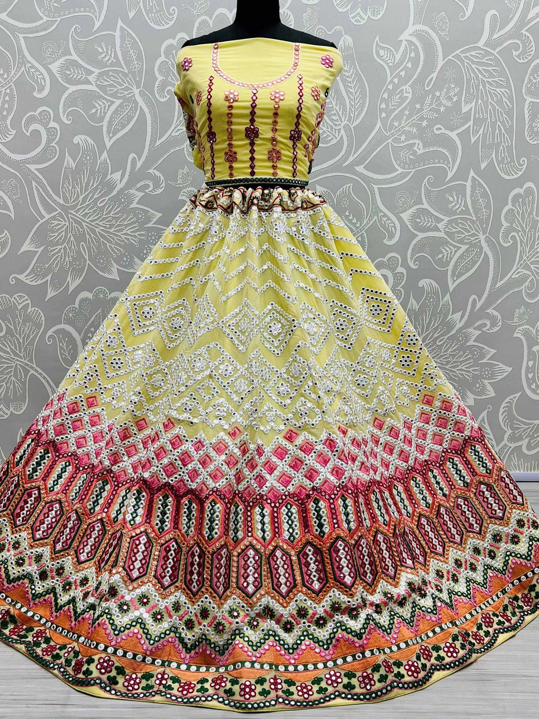 Yellow designer lehenga choli with mirror work and floral embroidery, ethnic Indian wear