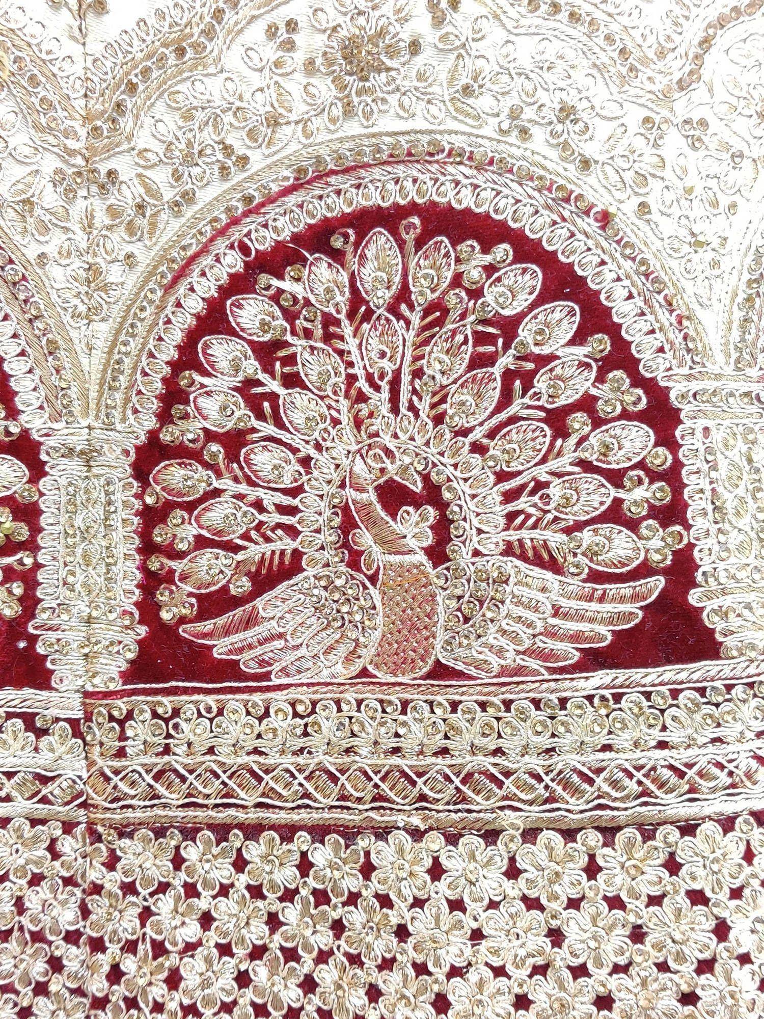 Luxury Indian ethnic wear with intricate peacock embroidery, gold threadwork, and maroon velvet fabric