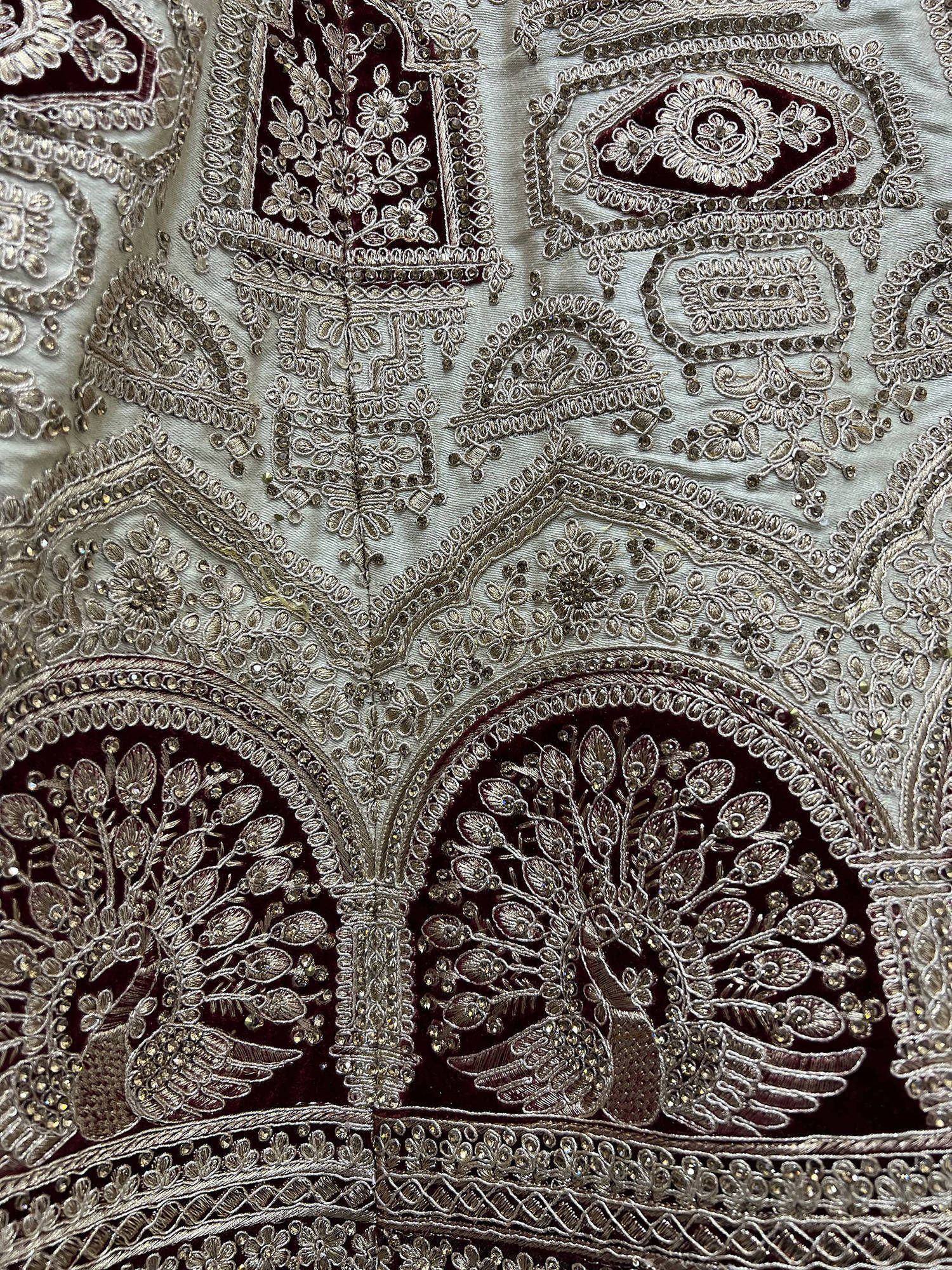 Luxury Indian ethnic wear with intricate silver embroidery and peacock motifs on velvet fabric