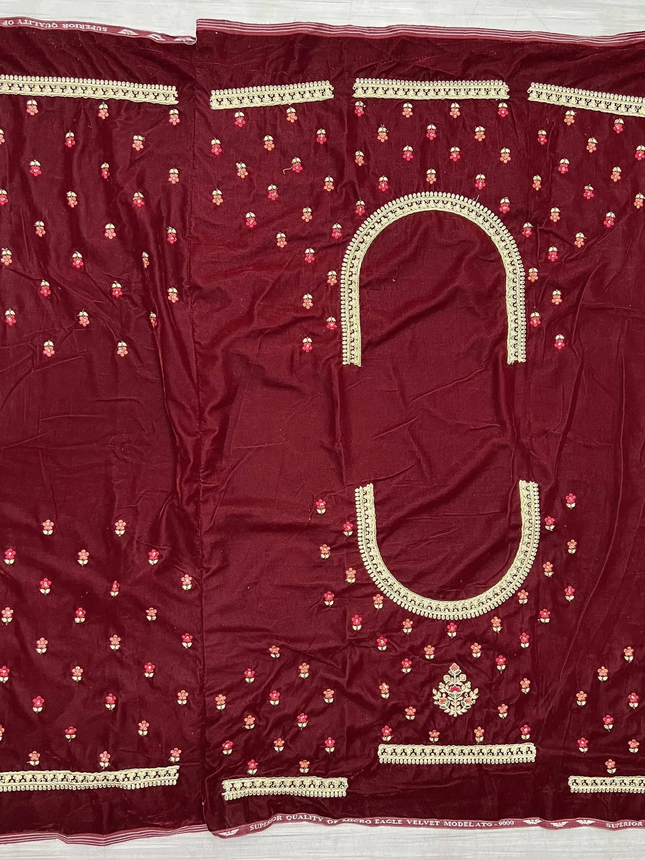 Maroon velvet ethnic dress fabric with floral embroidery and gold trim, ideal for designer salwar kameez or lehenga.