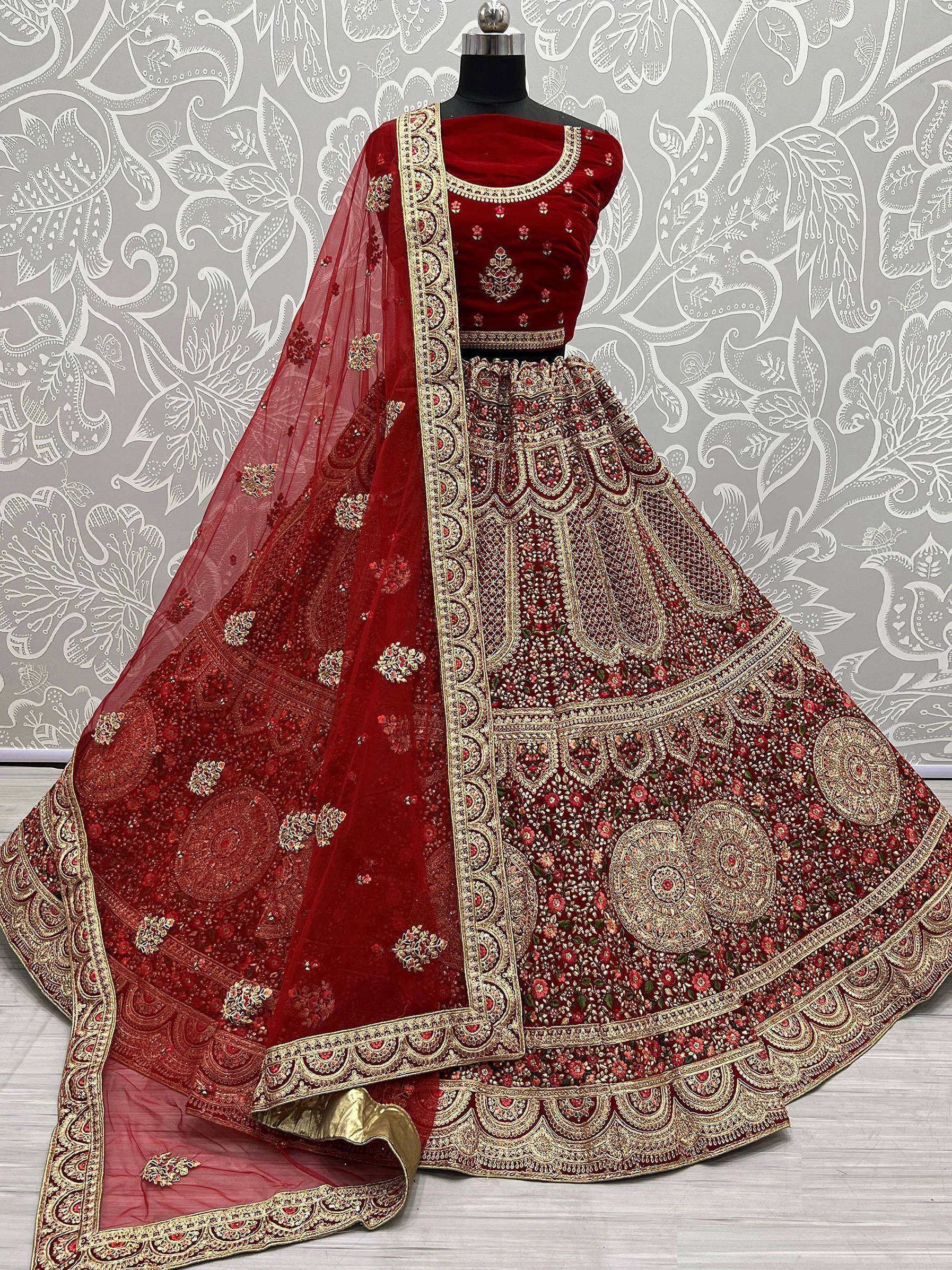 Red velvet designer lehenga choli with heavy gold embroidery and matching dupatta, ideal for weddings and festivals