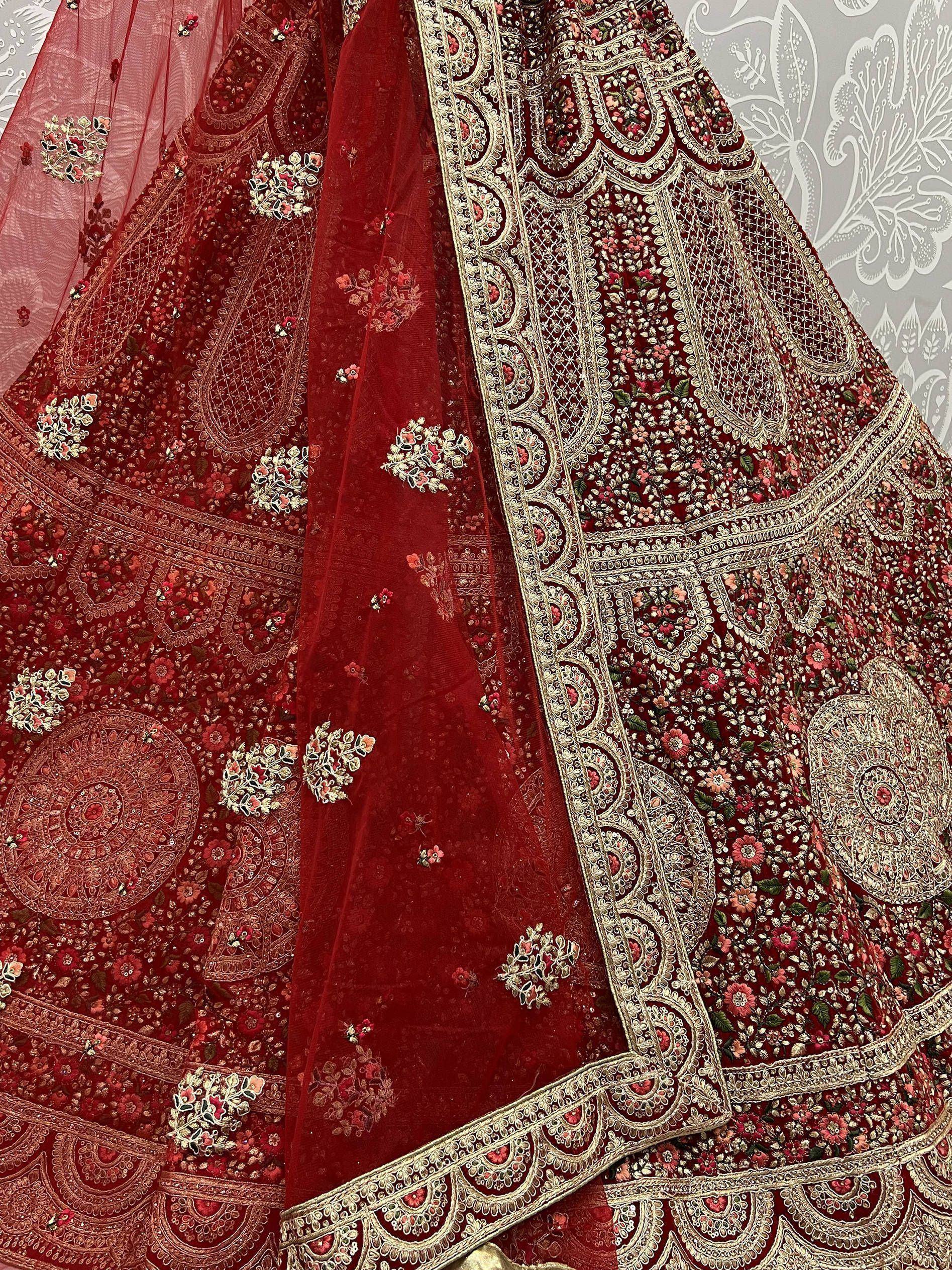 Red embroidered lehenga choli with gold floral patterns and net dupatta, Indian ethnic wear