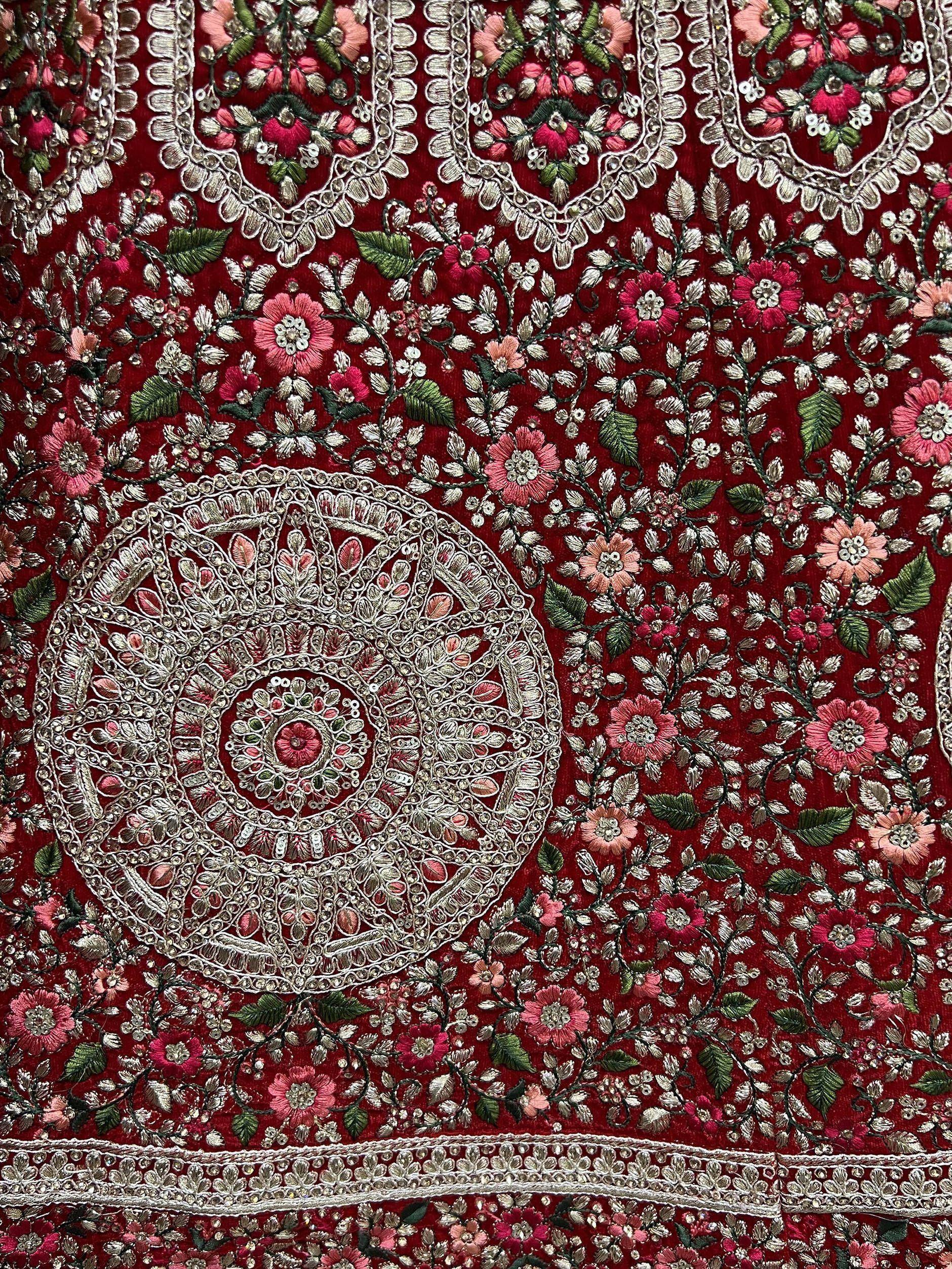 Rich red velvet with intricate floral embroidery and silver zari work, perfect for ethnic wear.