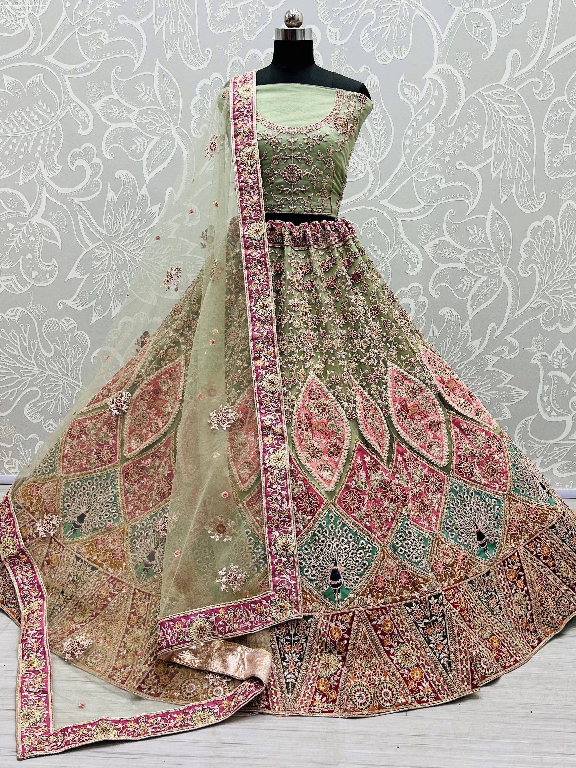 Designer lehenga choli with intricate embroidery, floral patterns, and peacock motifs in green and pink hues.