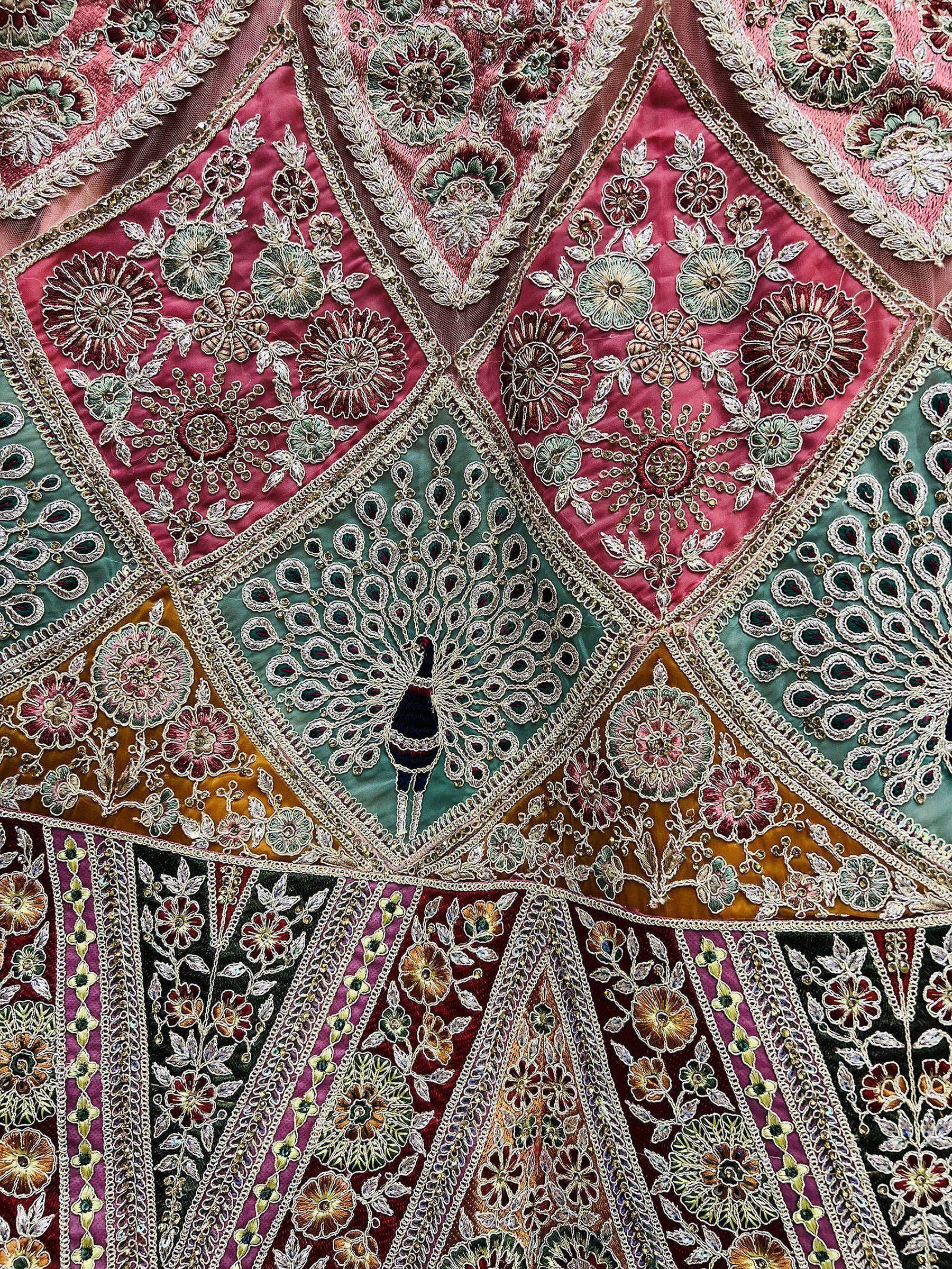 Indian ethnic wear with intricate floral and peacock embroidery on rich velvet fabric