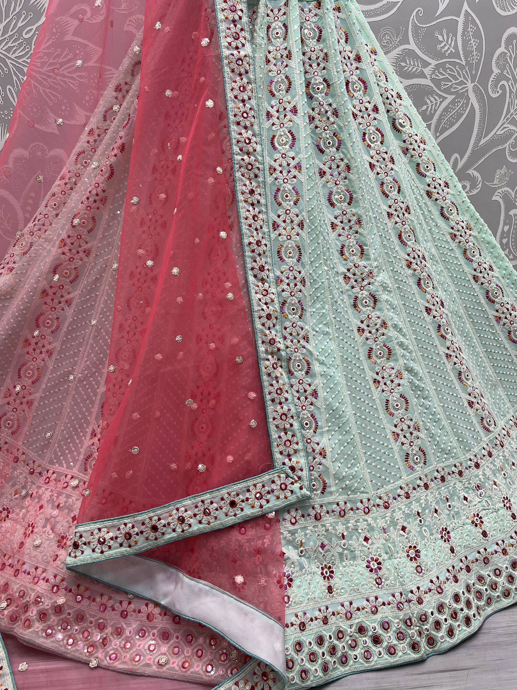 Mint green and pink embroidered lehenga choli with floral mirror work and sheer dupatta, ideal for Indian ethnic wear.