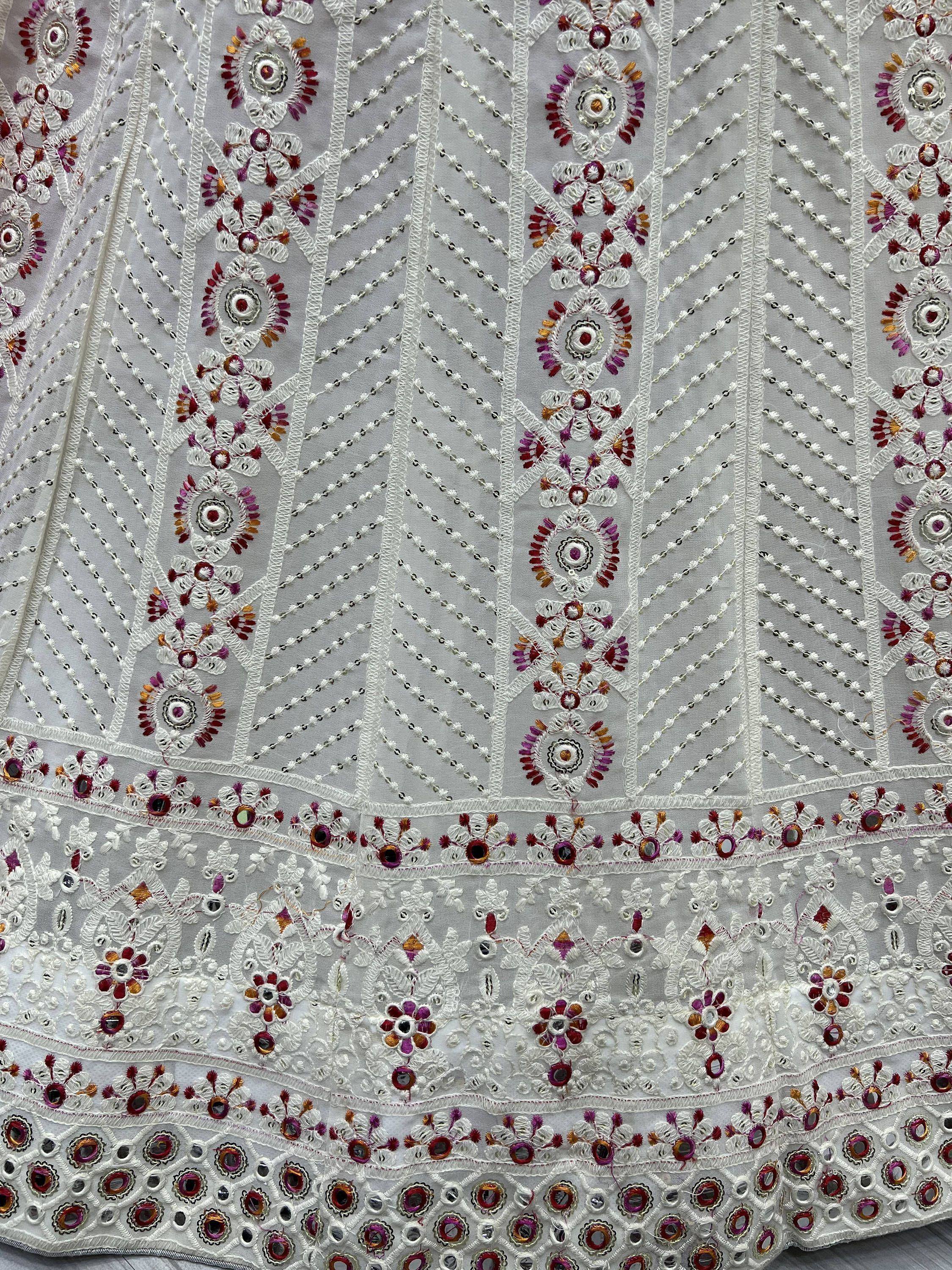 White ethnic wear with intricate floral embroidery and mirror work, perfect for Indian designer lehenga or saree.