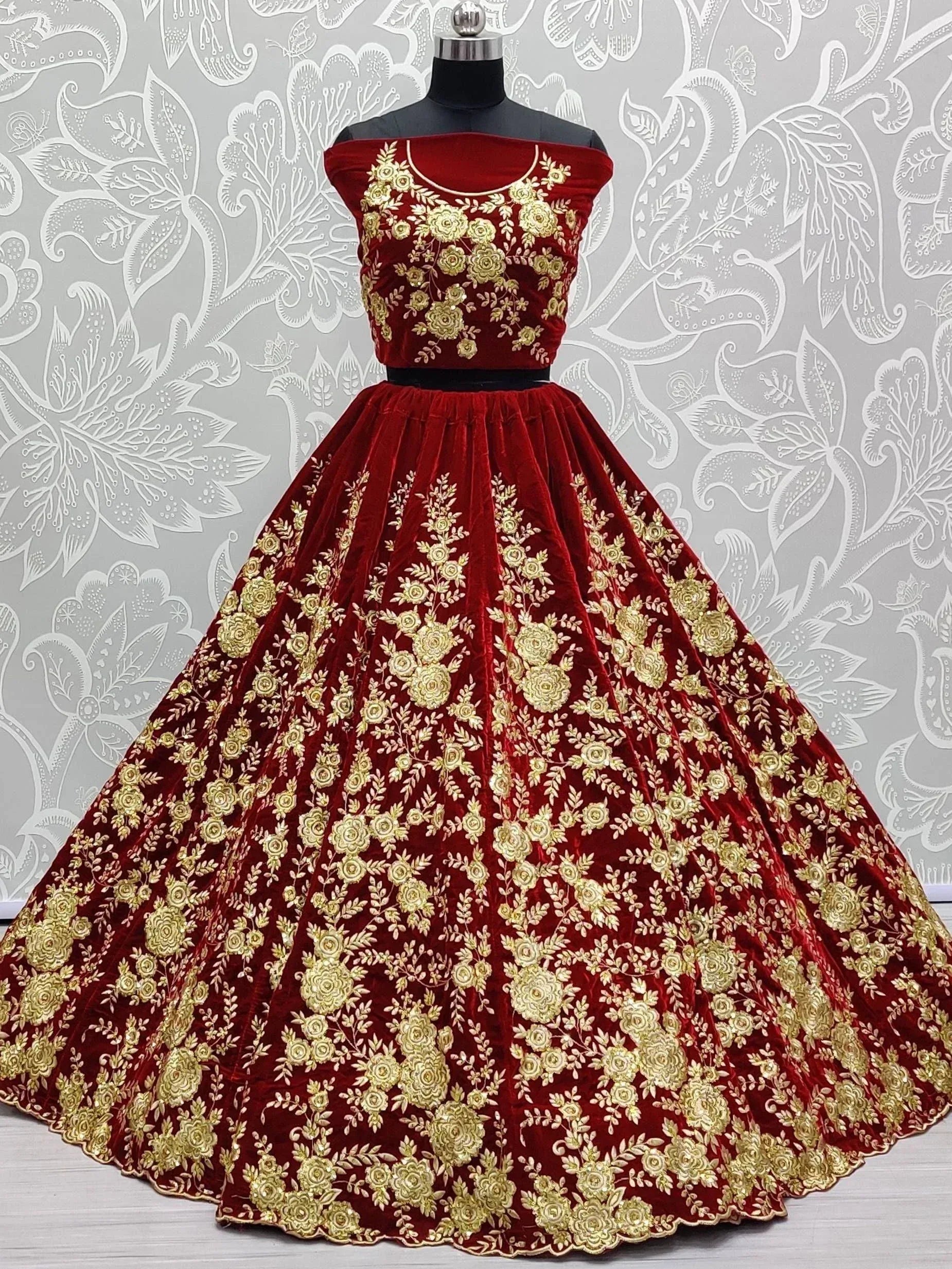 Red velvet lehenga choli with gold floral embroidery, off-shoulder top, ethnic wear for weddings