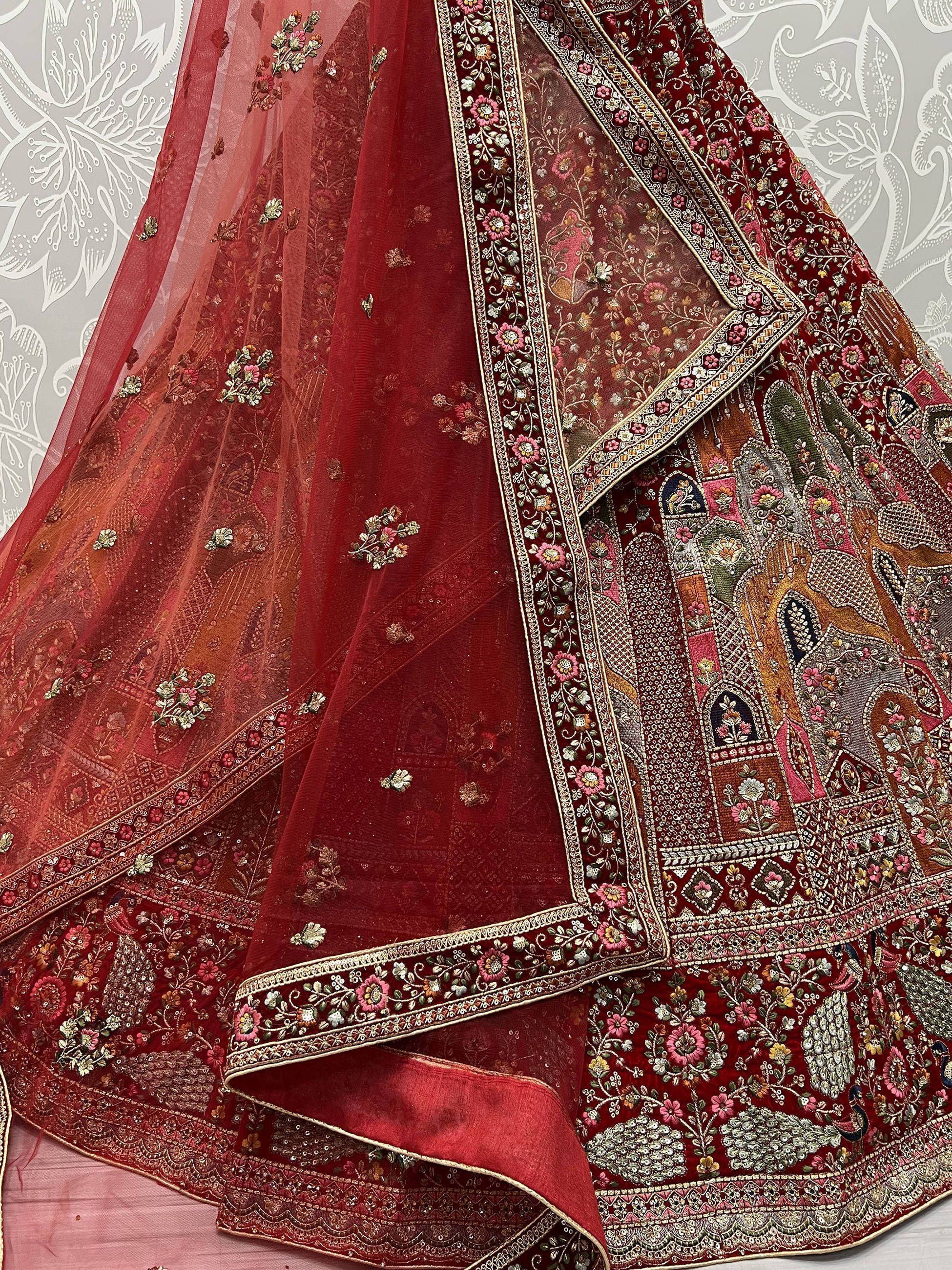 Red embroidered lehenga choli with floral motifs and sheer dupatta, Indian ethnic wear