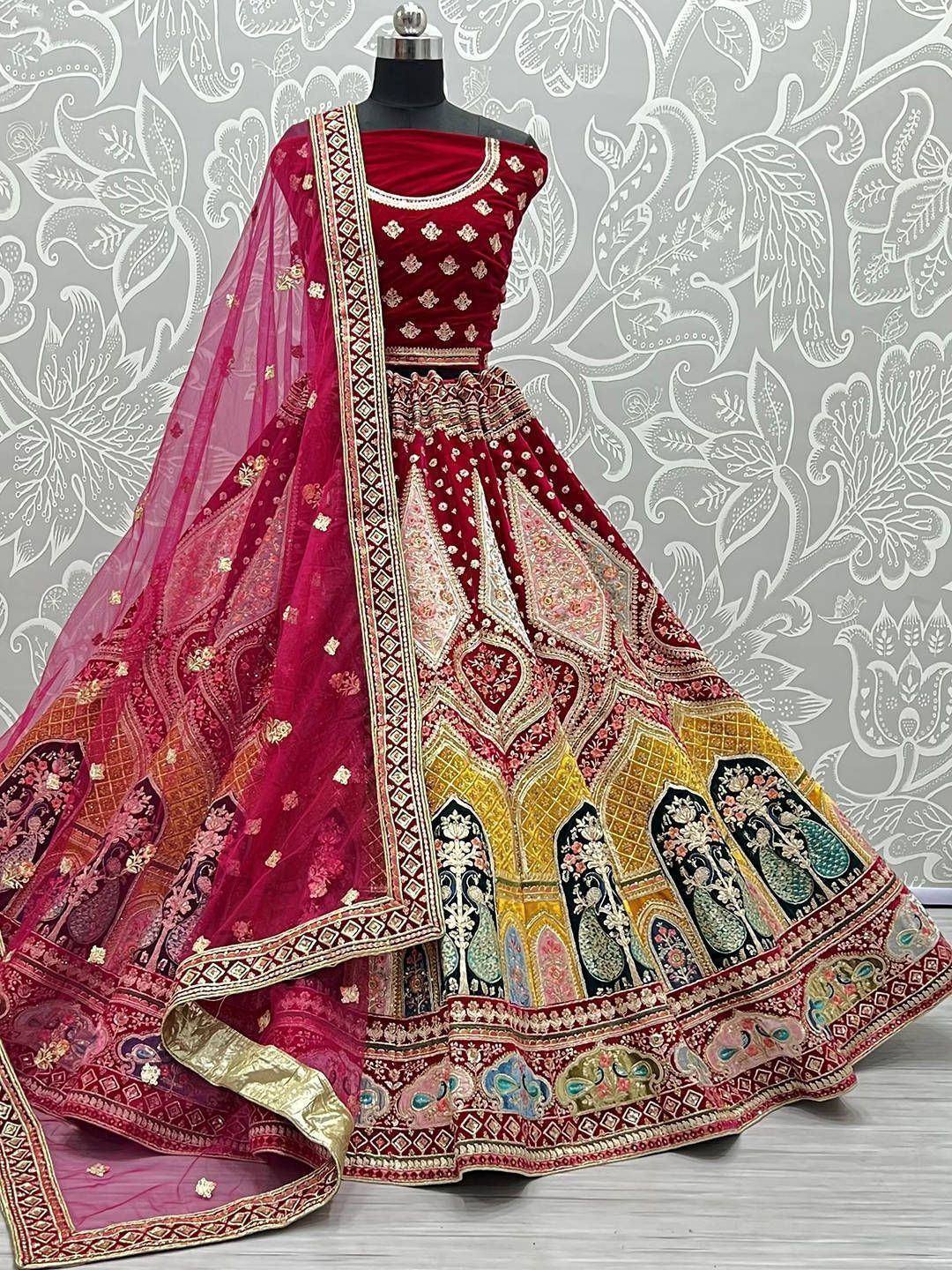 Red designer lehenga choli with intricate embroidery and peacock motifs, perfect for Indian weddings and festive occasions.
