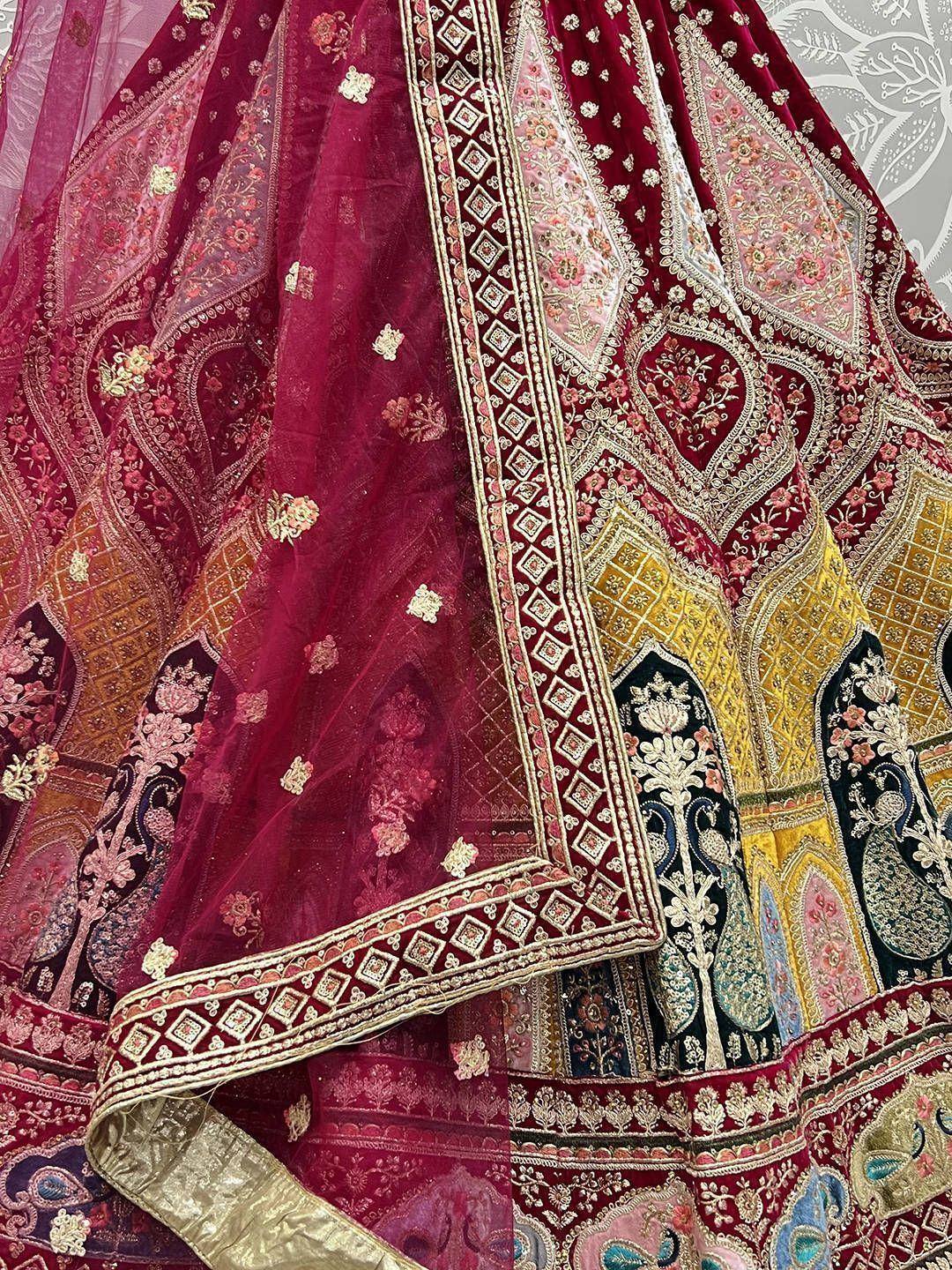 Luxury maroon lehenga with intricate gold embroidery and colorful patchwork design