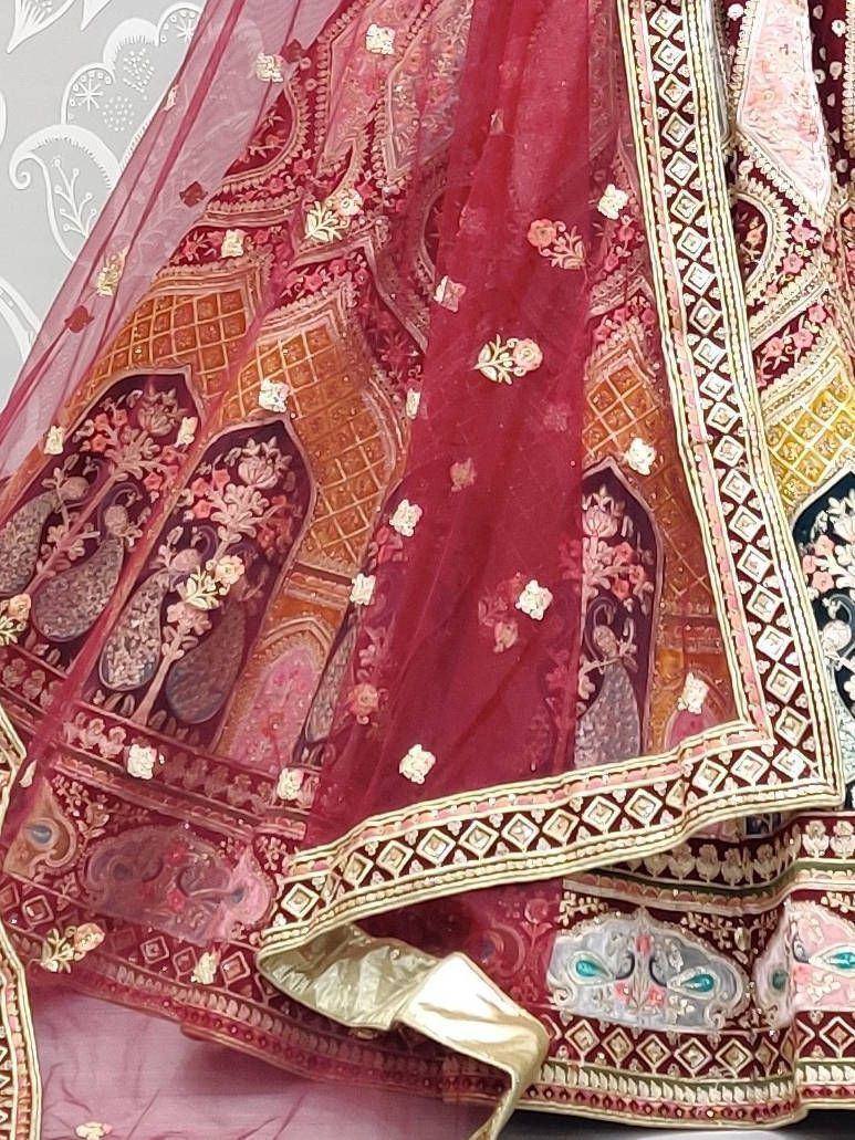 Rich maroon lehenga with intricate gold embroidery and floral motifs, perfect for Indian ethnic wear.