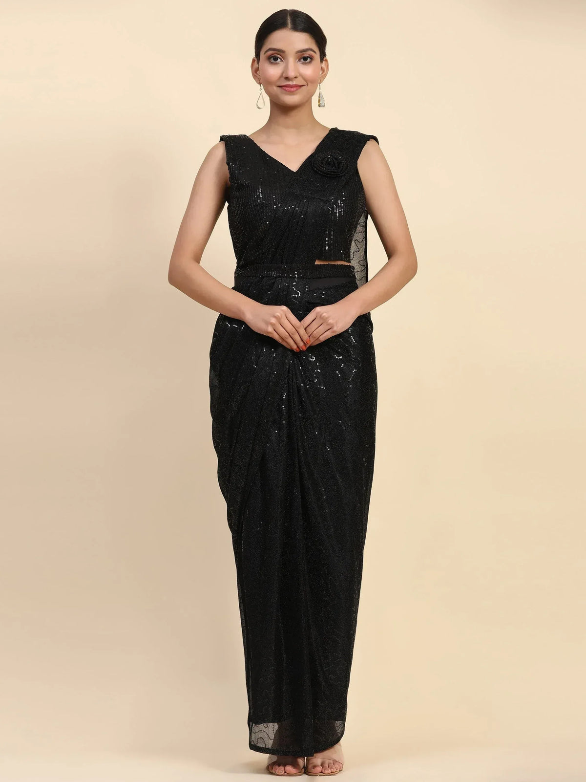 Black sequin saree gown with V-neck and floral embellishment, perfect for ethnic events