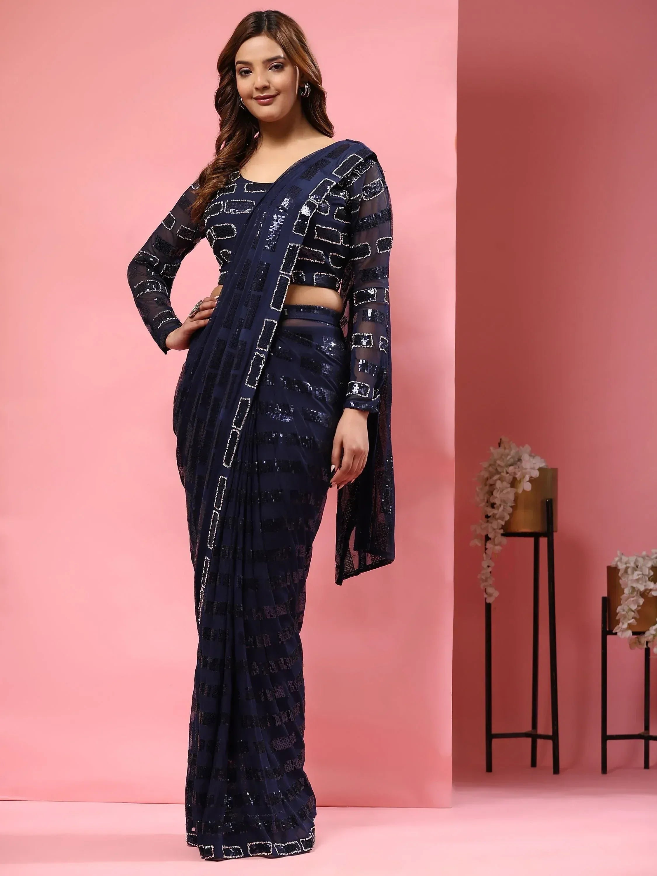 Navy blue sequin saree with geometric pattern, sheer long sleeves, and crop top for ethnic wear