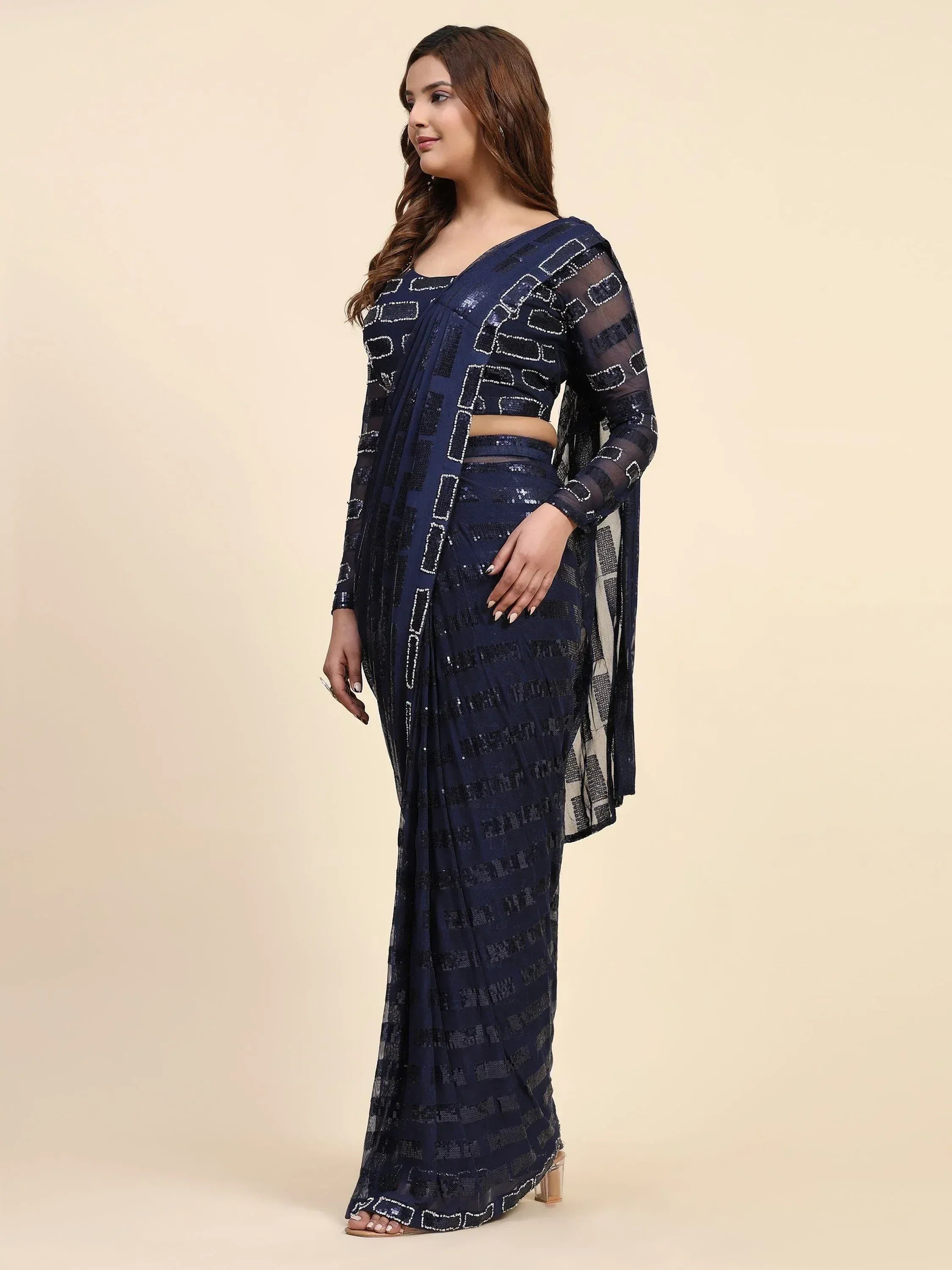 Navy blue sequin saree with geometric pattern, sheer sleeves, and crop top for ethnic wear