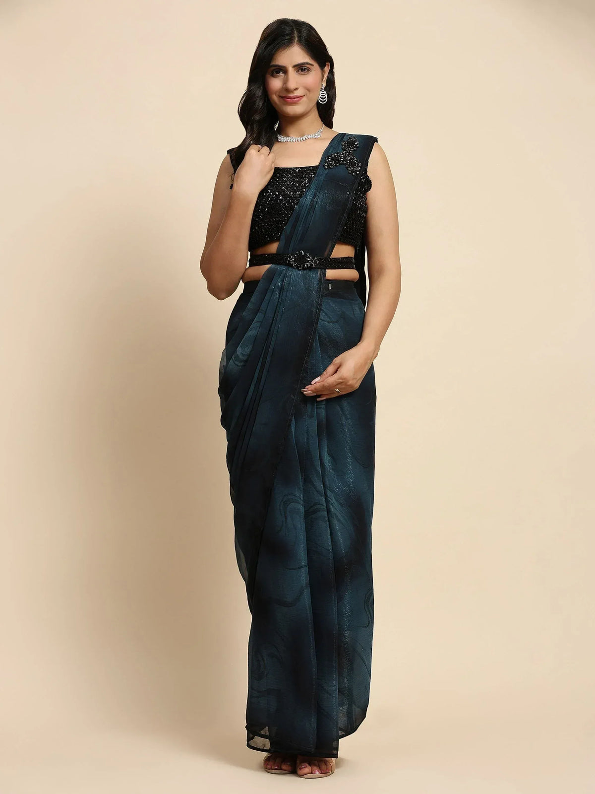 Woman in dark teal designer saree with black sequin blouse and belt, Indian ethnic wear