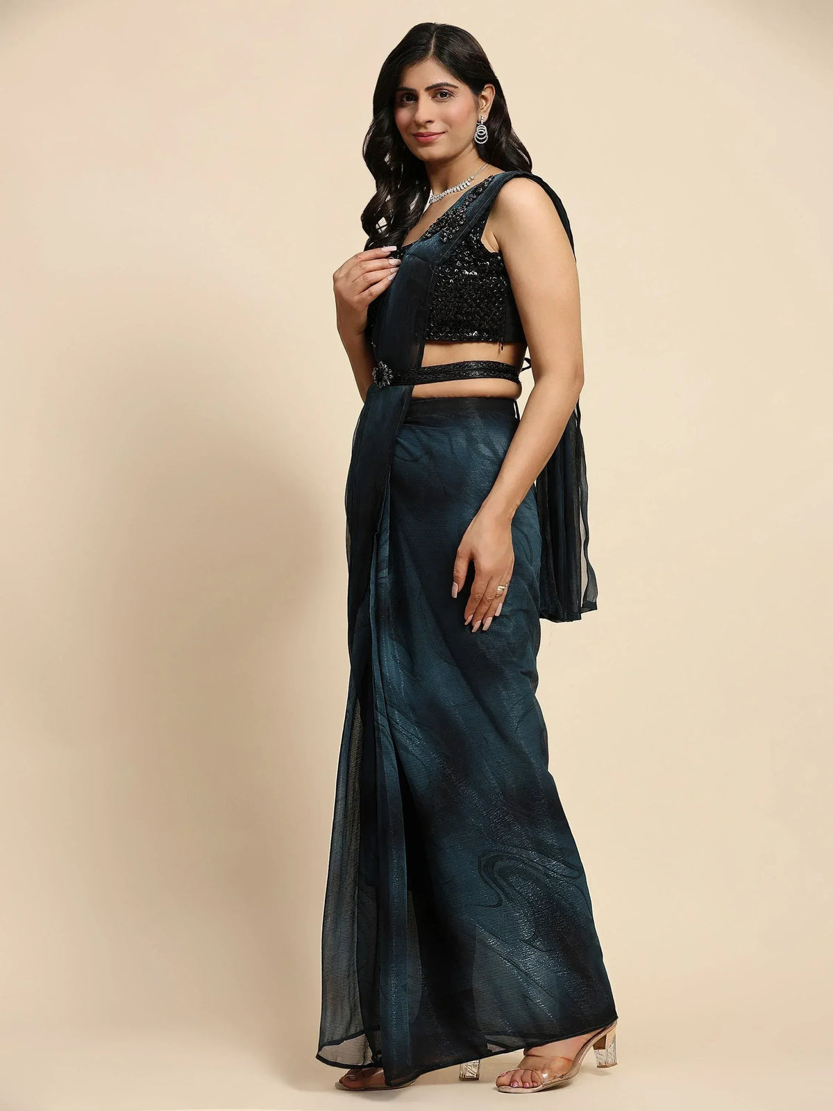 Woman in elegant dark blue saree with sequined blouse, perfect for Indian ethnic occasions