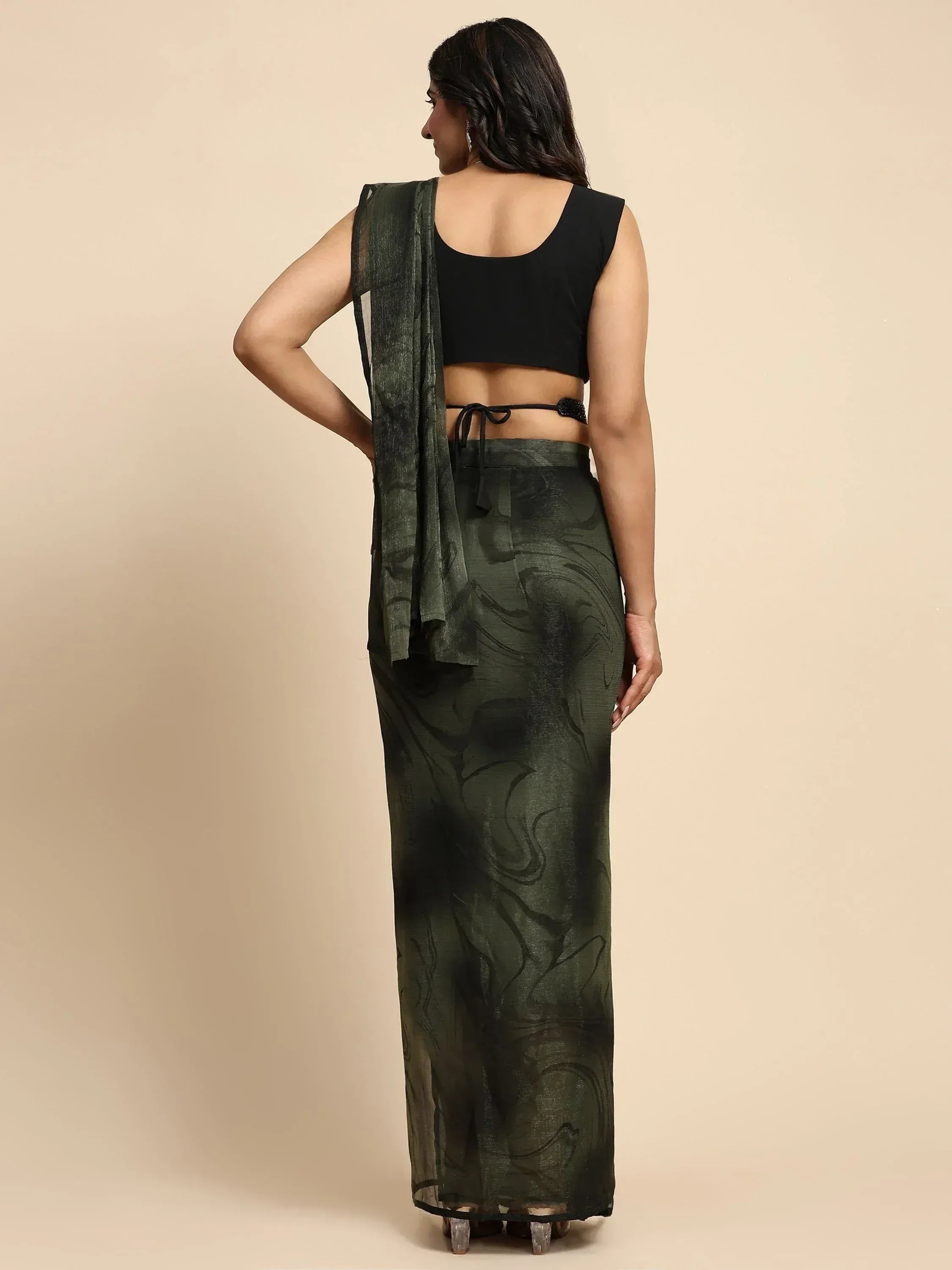 Black crop top with olive green printed saree skirt and sheer drape, back view ethnic wear