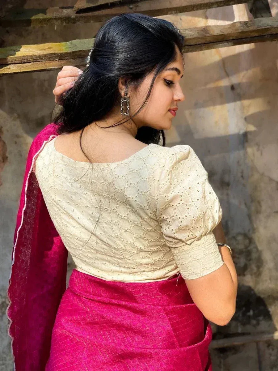 Woman in cream embroidered blouse with pink saree, ethnic Indian wear