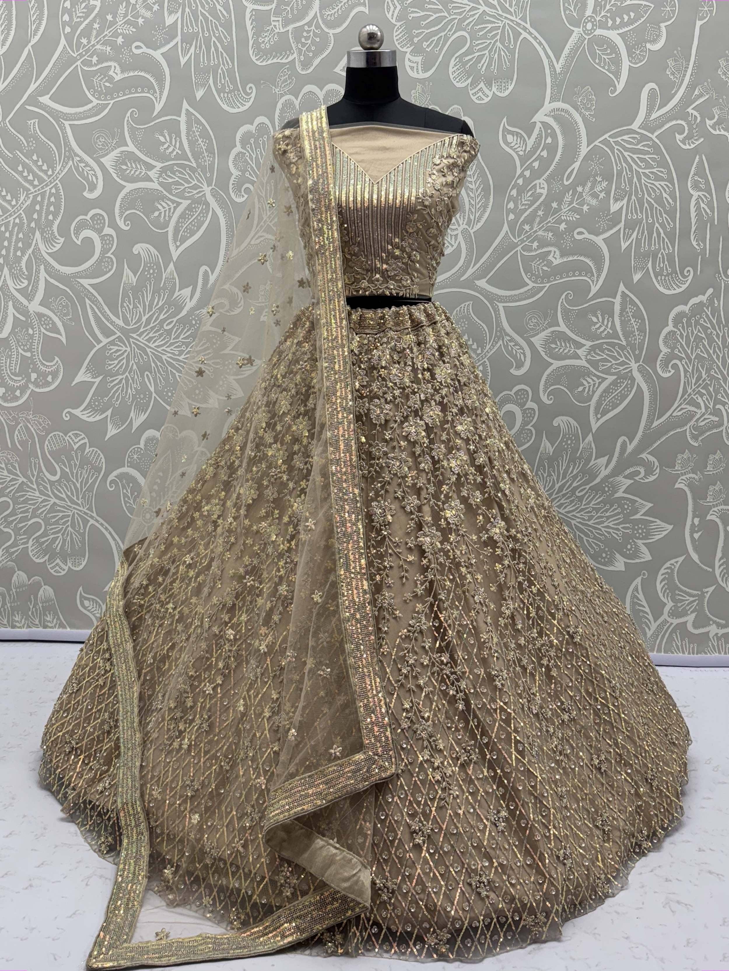 Gold embroidered lehenga choli with net dupatta, designer Indian ethnic wear for weddings