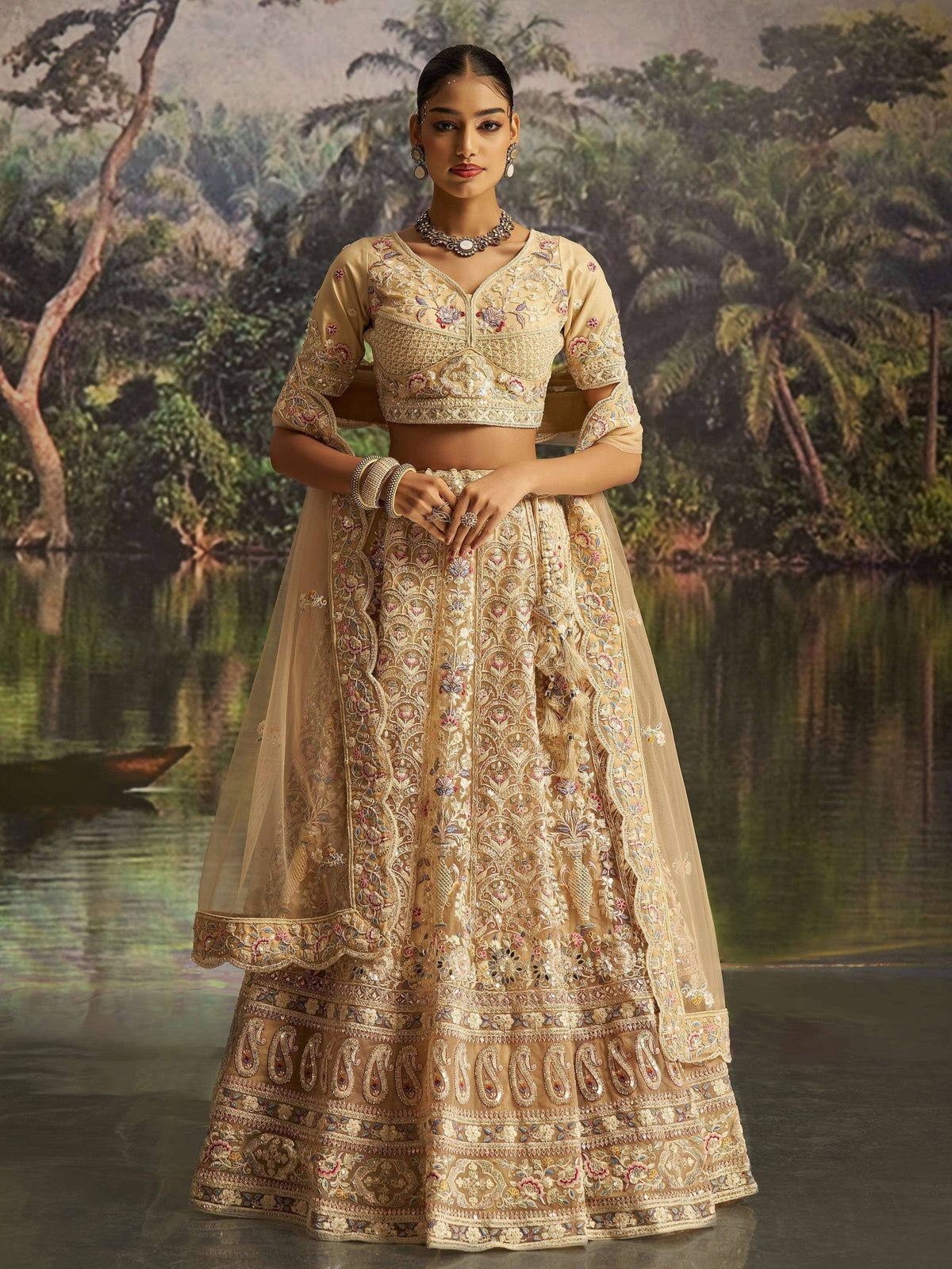 Elegant beige embroidered lehenga choli with floral motifs, perfect for Indian weddings and festive occasions.