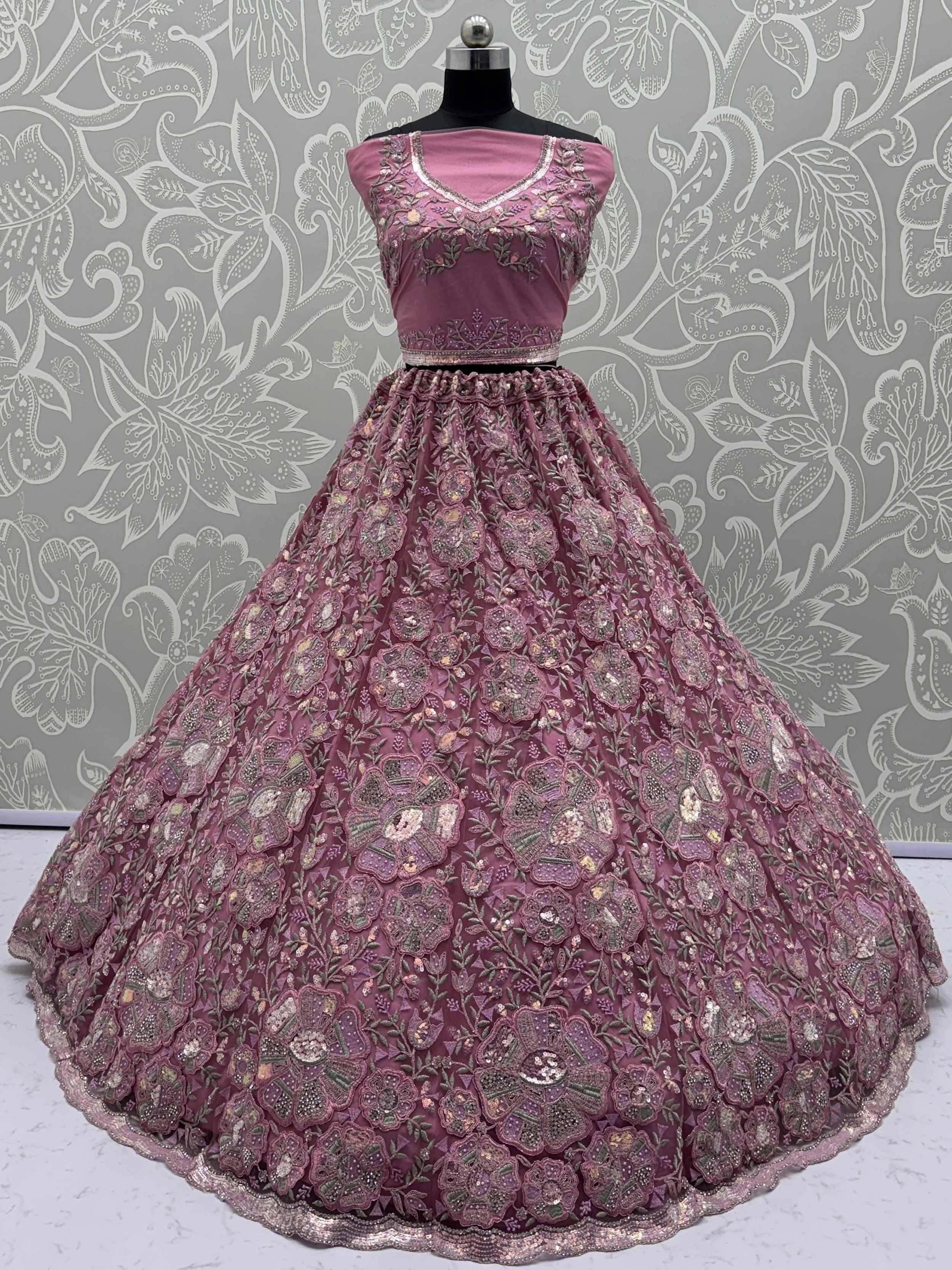 Pink embroidered lehenga choli with floral motifs, perfect for Indian weddings and festive occasions