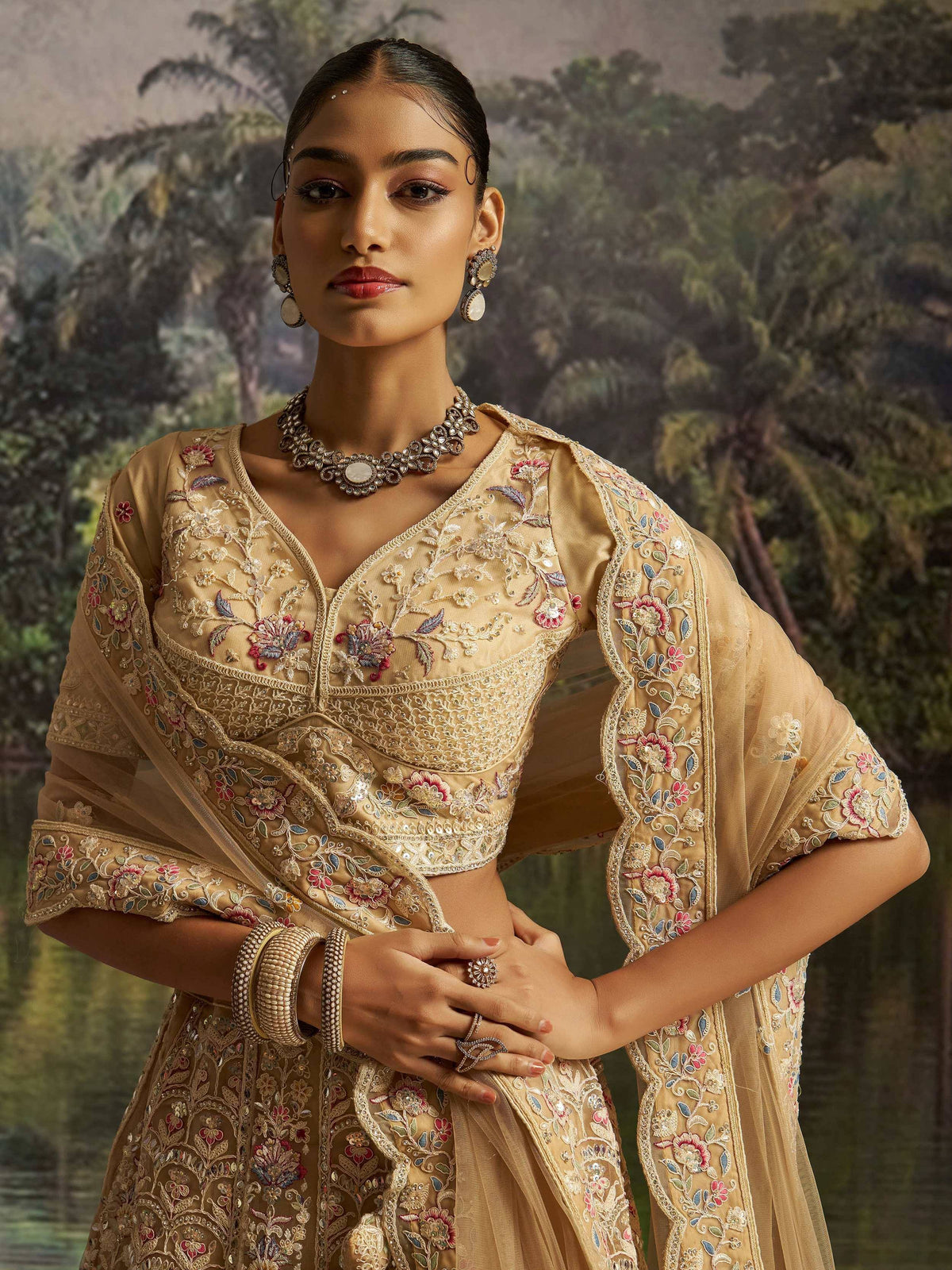 Elegant gold embroidered lehenga choli with floral motifs, perfect for Indian ethnic wear occasions.