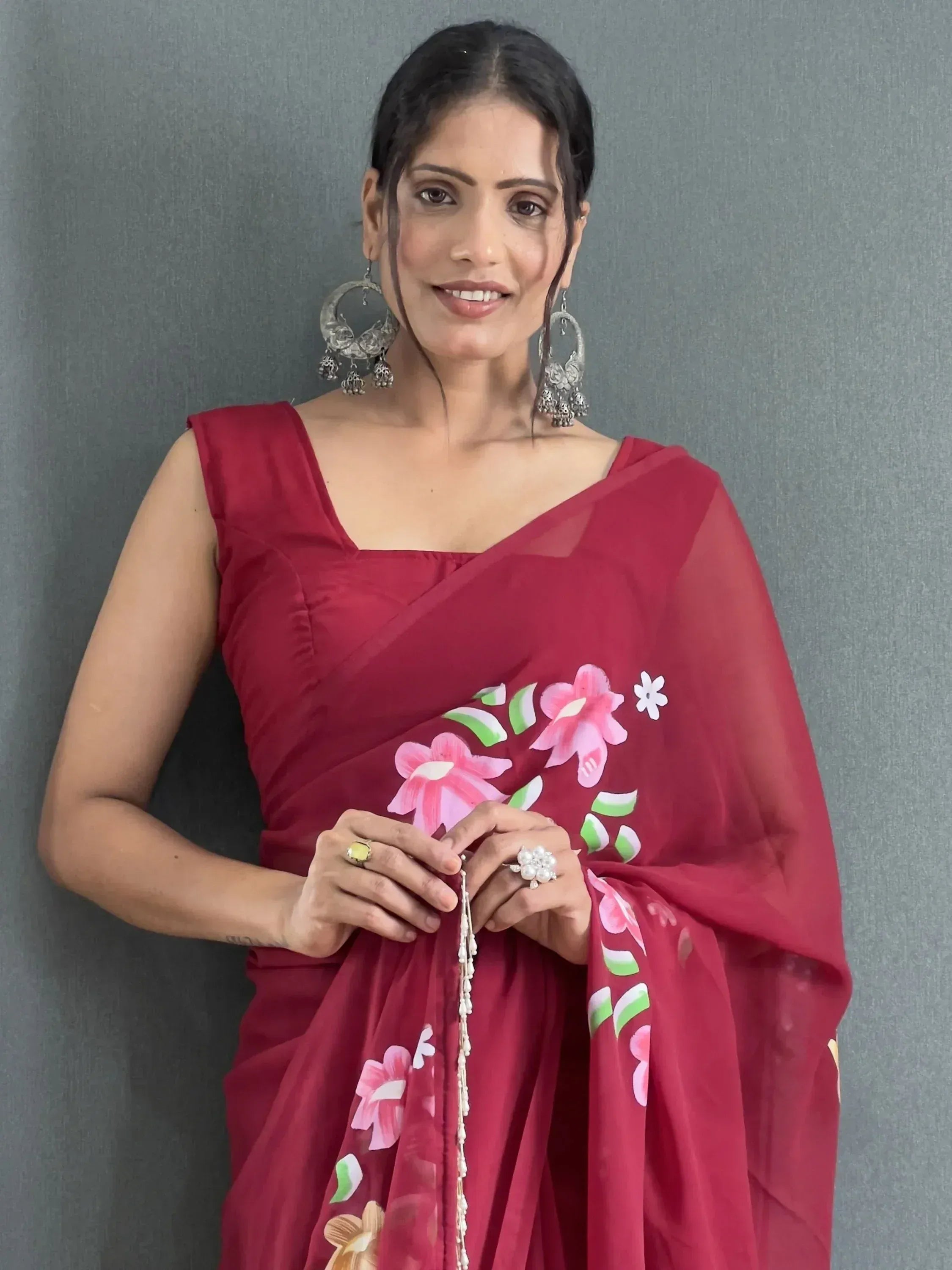 Woman in red floral saree with silver jhumka earrings, Indian ethnic wear