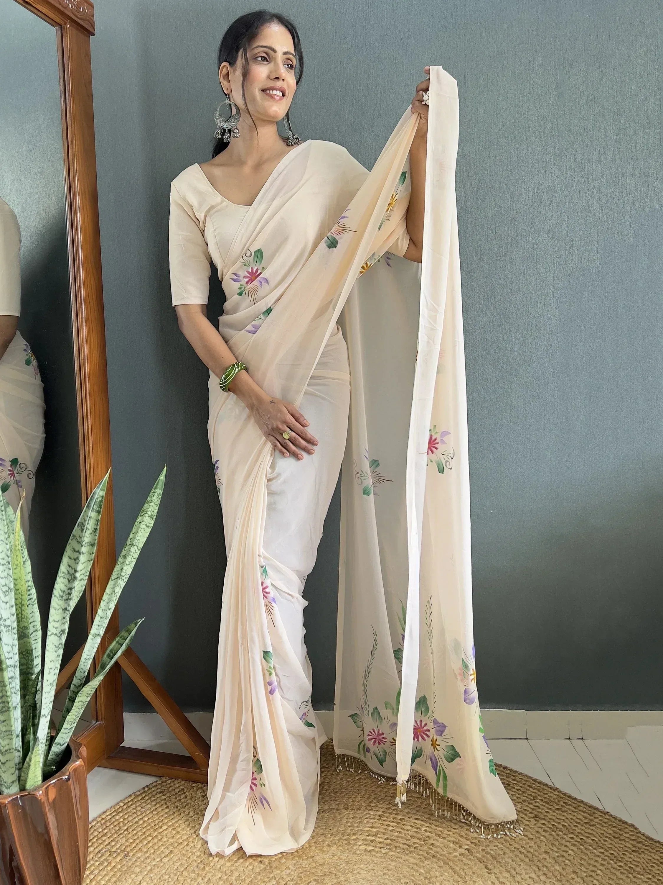 Woman in cream floral printed saree with matching blouse, ethnic Indian wear
