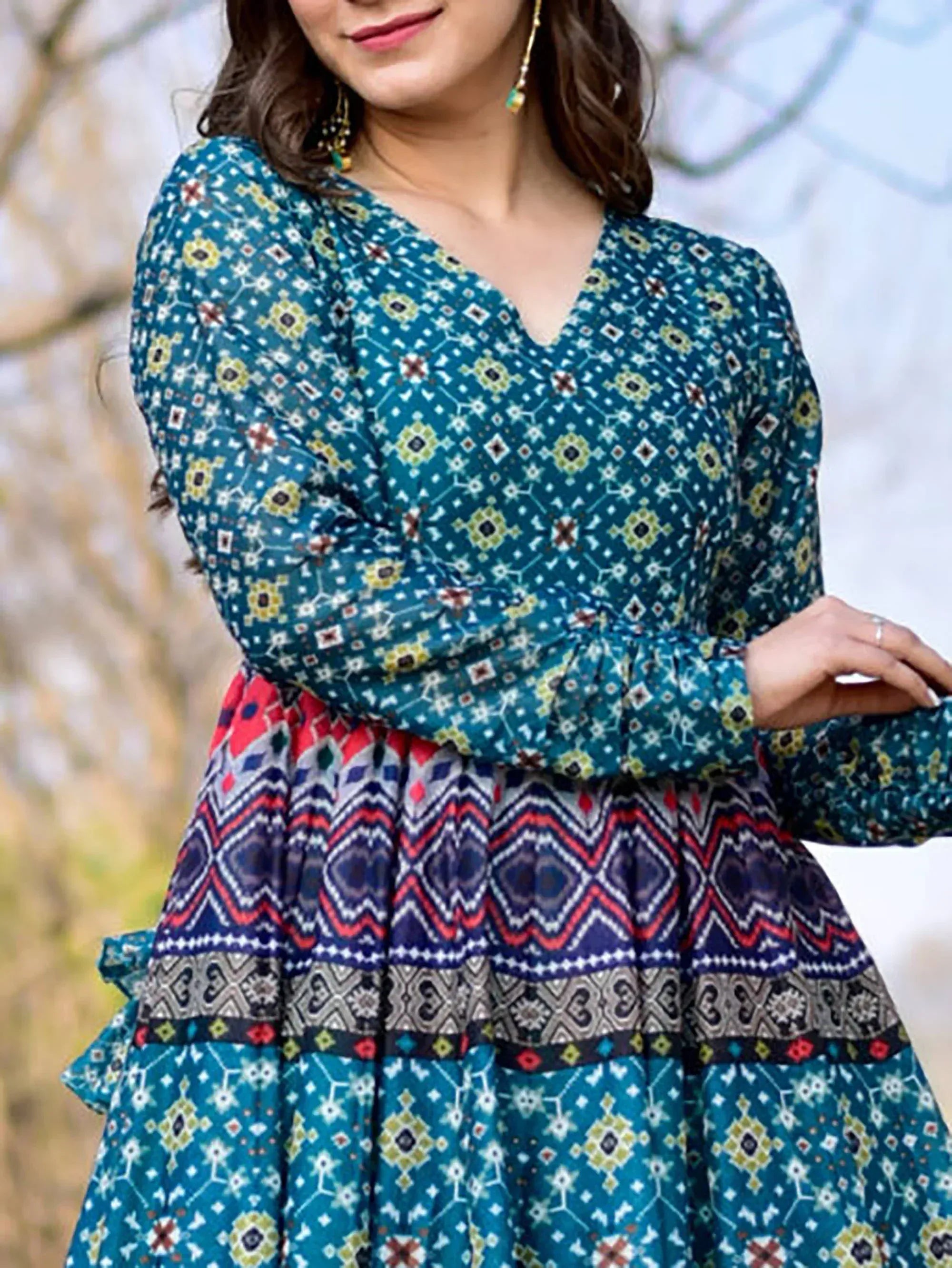 Teal ethnic printed gown with geometric patterns and flared skirt, perfect for Indian occasions.